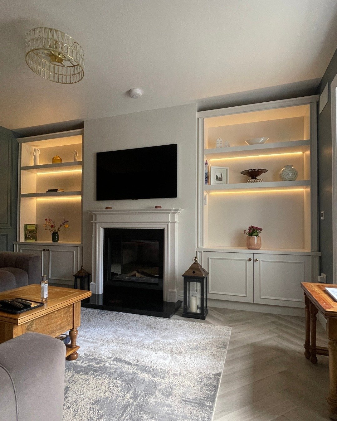These alcoves quickly become the part of the room that gets used every day. Finished in Colourtrend's 'Temperance' with oak interiors, the cabinets keep everyday essentials tucked away, while floating shelves with recessed LED strip lighting give boo