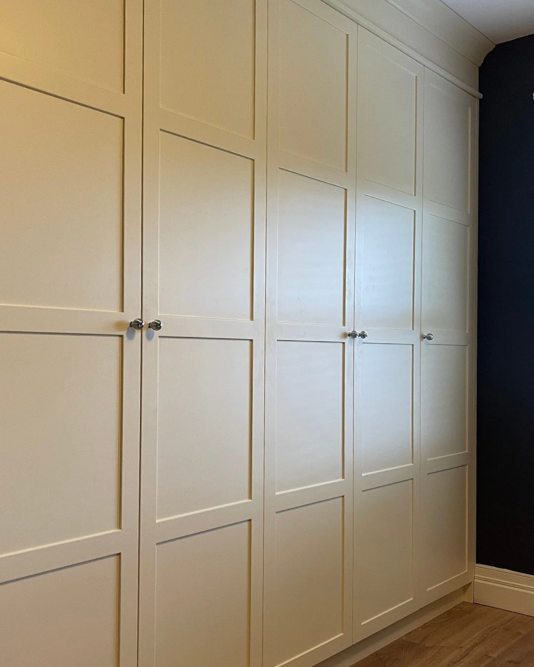 This bedroom feels calmer when everyday essentials have a dedicated place. Finished in 'French White', the wardrobe keeps clothes organised with shelves for extras, a dedicated spot for shoes, and drawers for the smaller accessories that often get le