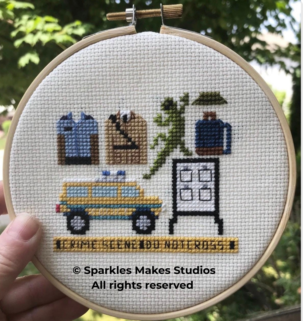 Cross-stitch embroidery featuring a worker with a hard hat, a tree, a gas tank, a car, a door, and a yellow caution tape that reads 'I CAME BECAUSE I DO NOT CROSS.'