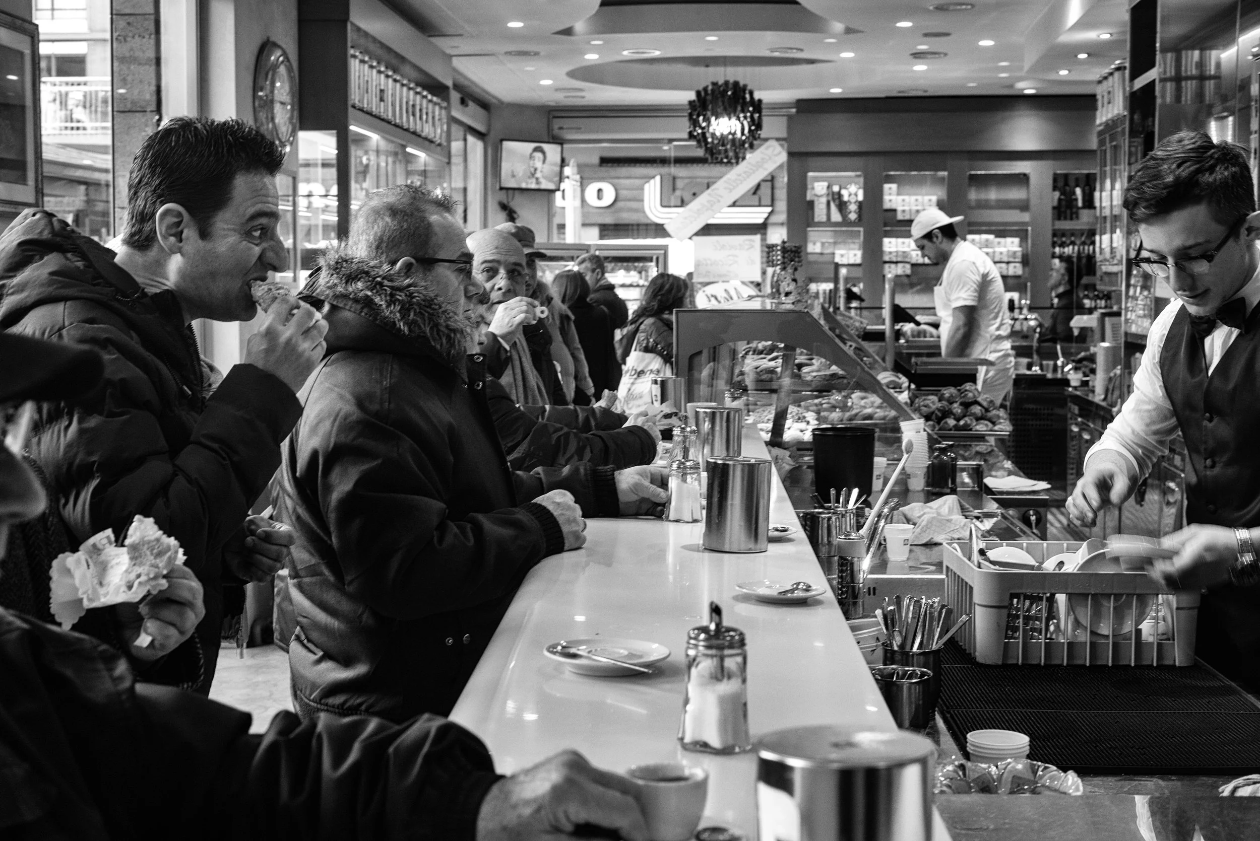 Men having a quick breakfast at a Rome cafe