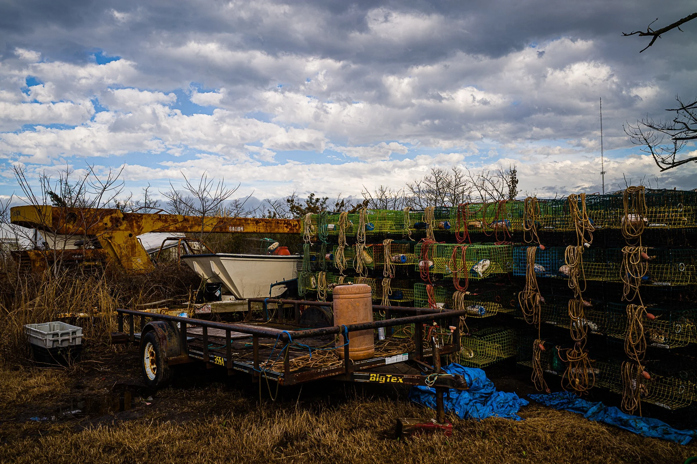 crab pots and a boat under cloudy blue sky