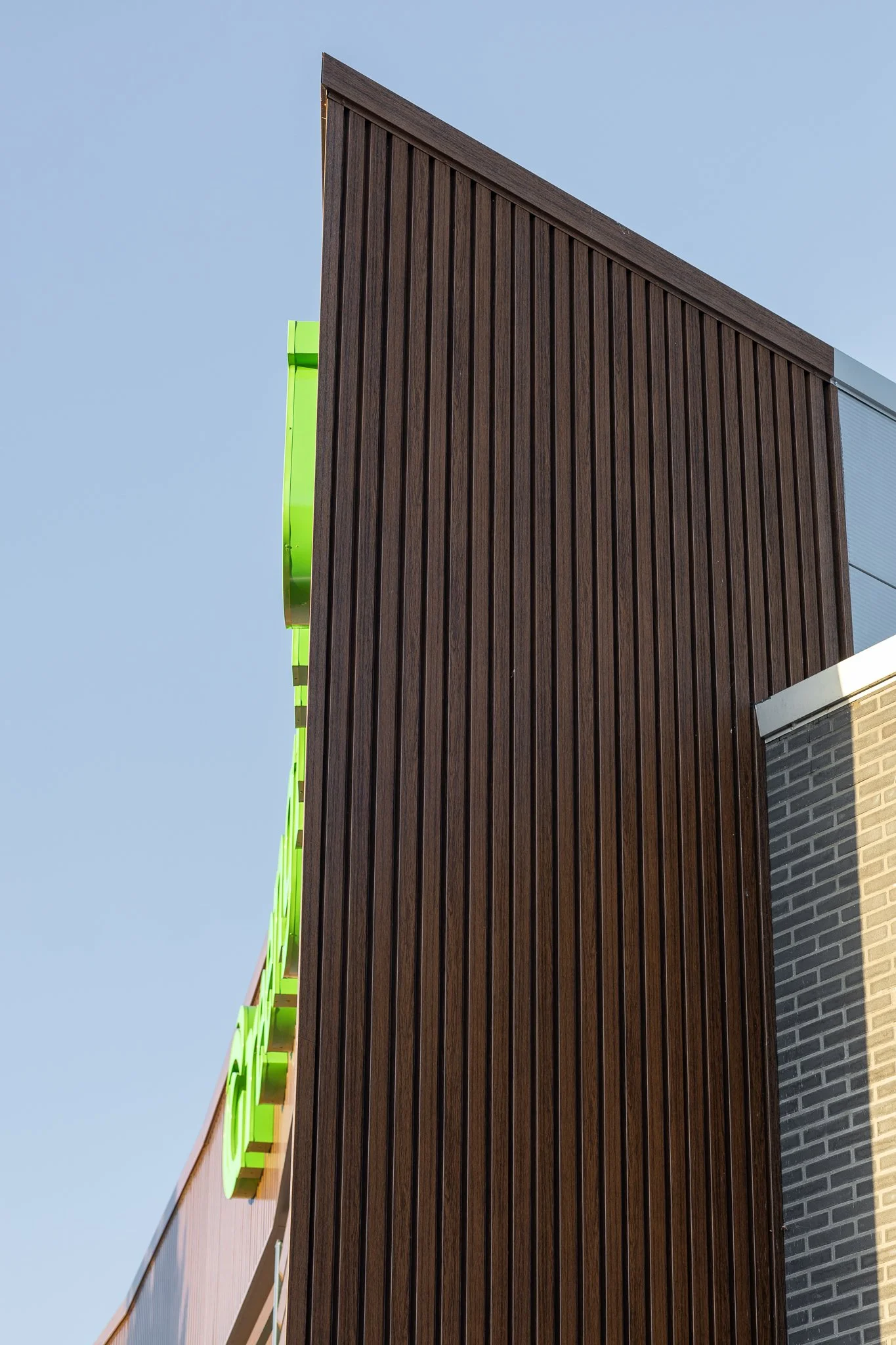 Angular roofline and vertical timber façade of the contemporary Greengiving office