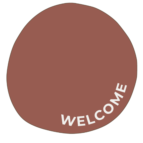 A round doormat with a brown background and the word 'WELCOME' in white letters curved along the bottom.