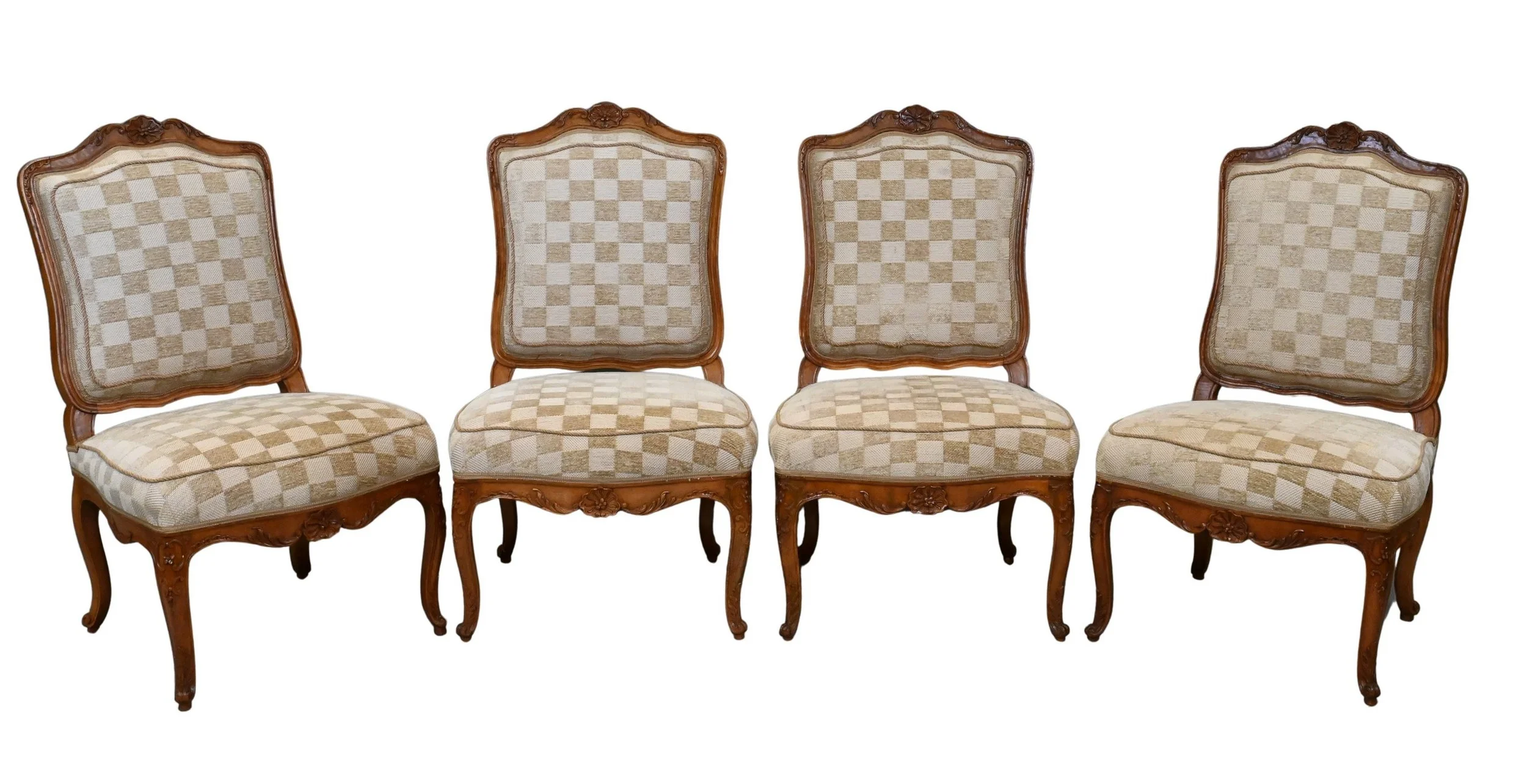 Set of Four Louis XV Carved Walnut Side Chairs
each with arched and molded crest rail carved with foliate motifs above a serpentine padded back and seat, upholstered in a cream checker-patterned fabric, raised on cabriole legs with floral-carved knee