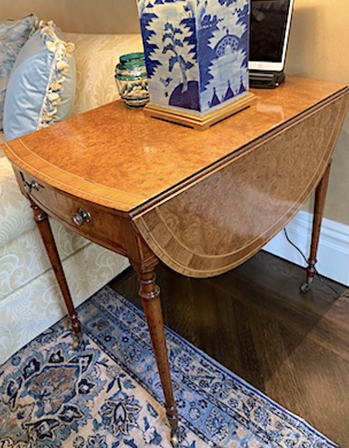 Important Pembroke Table in the manner of John Linnell; having an oval top veneered in burl ash, with rosewood and tulipwood banding, the frieze with a single drawer and brass pulls. England, c. 1775 (21 ¼ “ Wide (45 ¼ open) x 32 ¾” deep x 30” high)