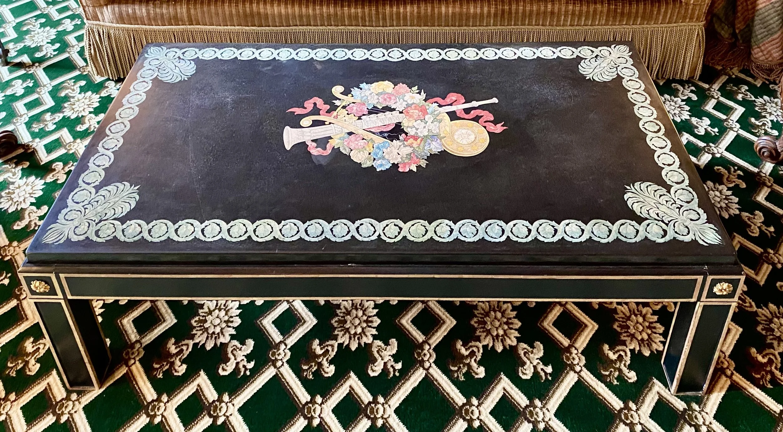 Fine Scagliola “Flue Entwined in Floral Wreath” Decorated Thick Black Marble with scrolling border, set into a modern ebonized and gilt trim base for use as a cocktail table (49 inches long x 24 ½ inches deep x 16 inches high)
