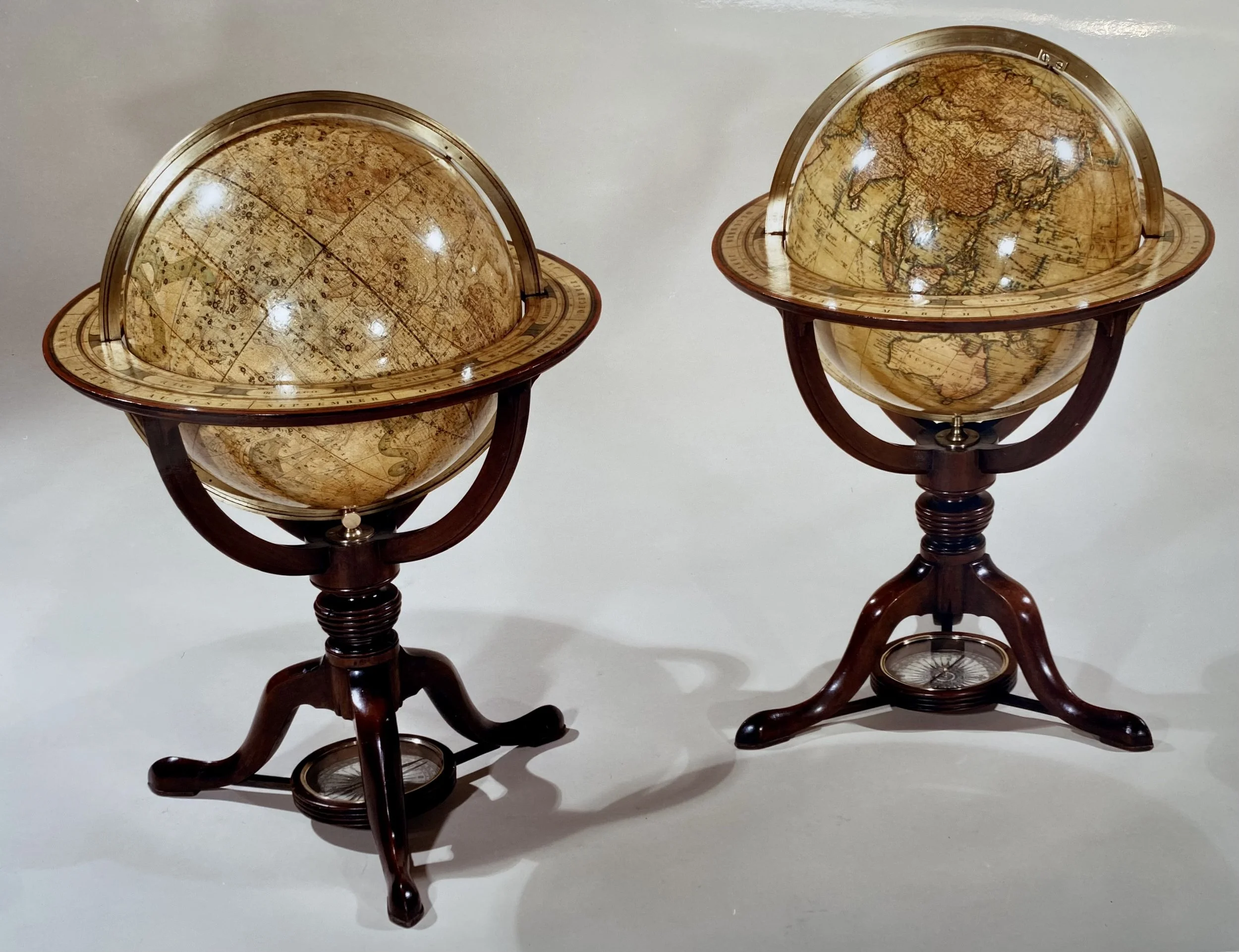 Very Fine Pair of George III Mahogany Table Globes (Celestial & Terrestrial) by CARY, Dated 1816, on tripod Bases each fitted with a compass below (18 inches diameter x 25 inches high) Provenance: Hotspur, London, 1988