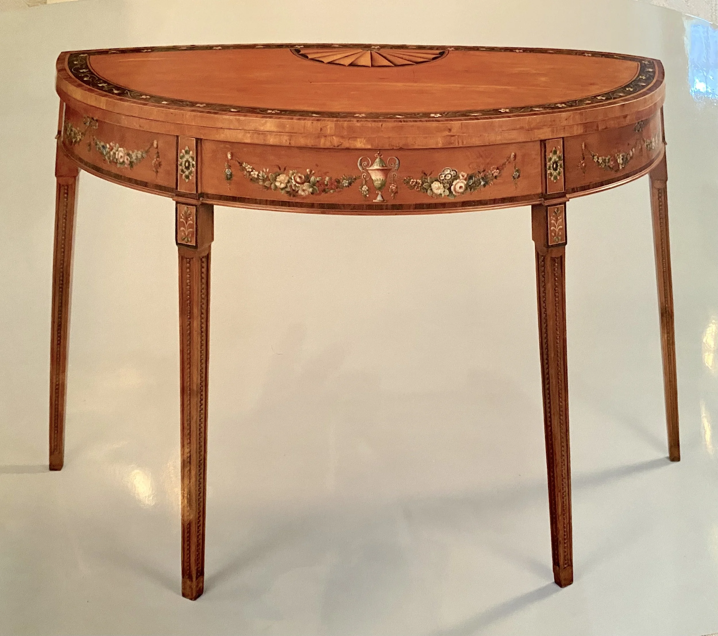 Pair of George III Satinwood Card Tables, the tops inlaid with paterae and with bands of painted floral decoration within a rosewood cross-banding, with painted frieze and square tapering legs unusually carved with beading, c. 1780 (48 inches wide x