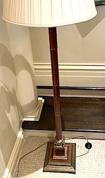 Neoclassical Style Brass and Burgundy Lacquered Floor Lamp,
With Four Stylized Dolphins on Squared Plinth Base, 20th Century