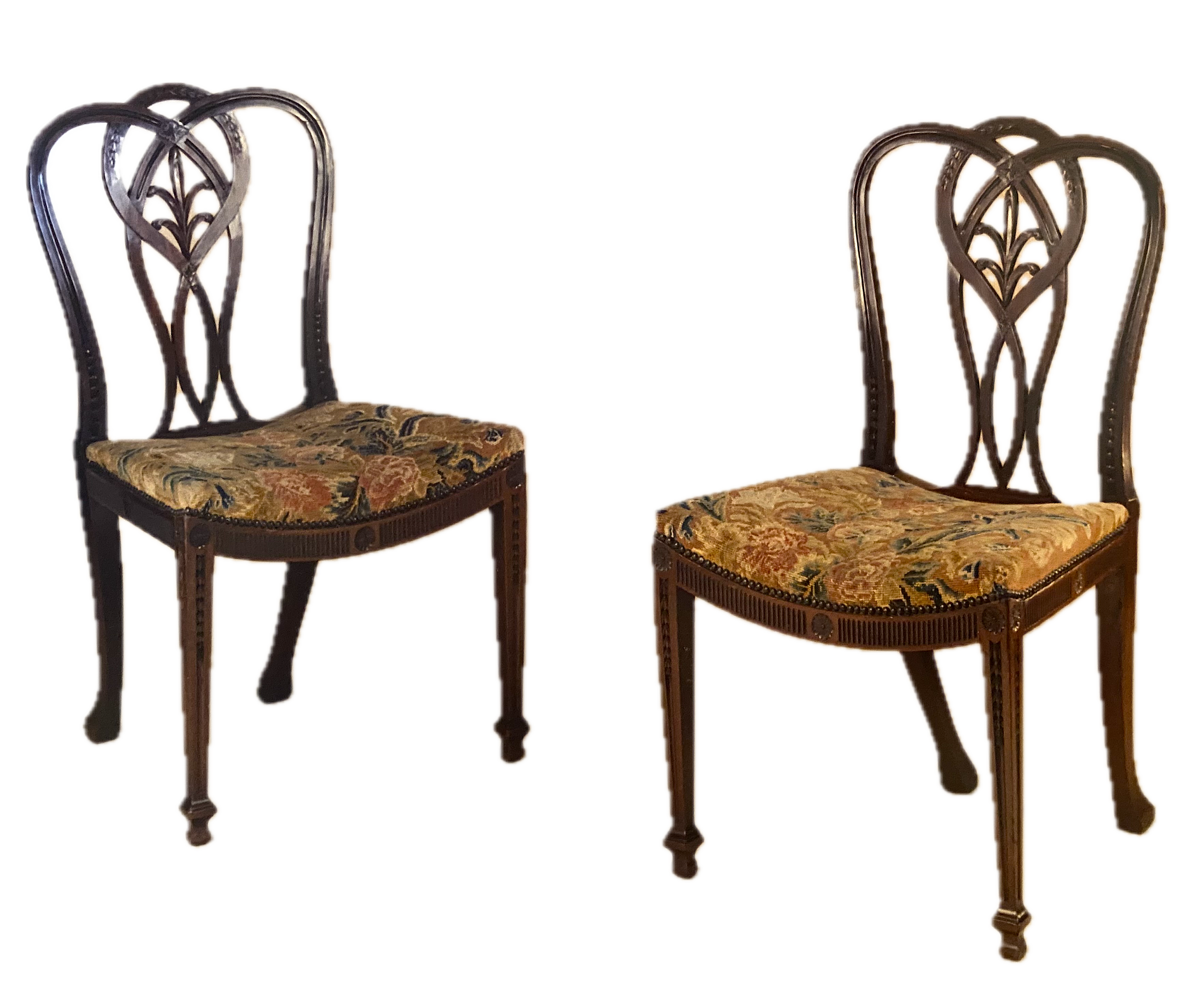 Rare Set of Four George III Adam Period Finely Carved Side Chairs, Retaining their original Needlework Upholstery, England, c. 1775 (21 ¼ inches wide). Provenance: Apter-Fredericks Ltd, London
