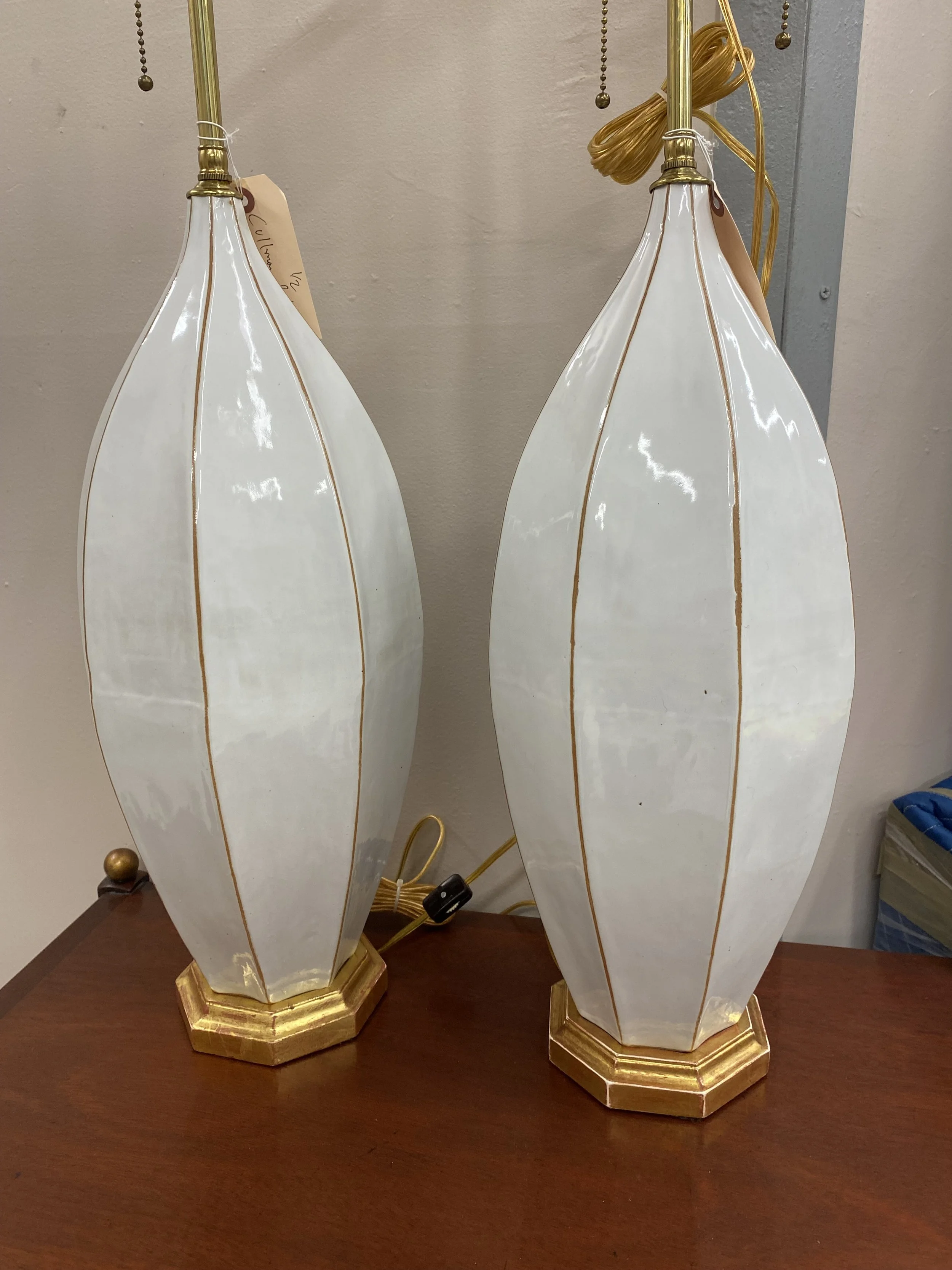 Pair of White Glazed Ceramic Ovoid Vases, Now Wired as Lamps on Giltwood Bases, with Shades
Provenance: Marvin Alexander Lighting, New York 
Size: Vases are 21 inches high; 32 inches high to shade rest
