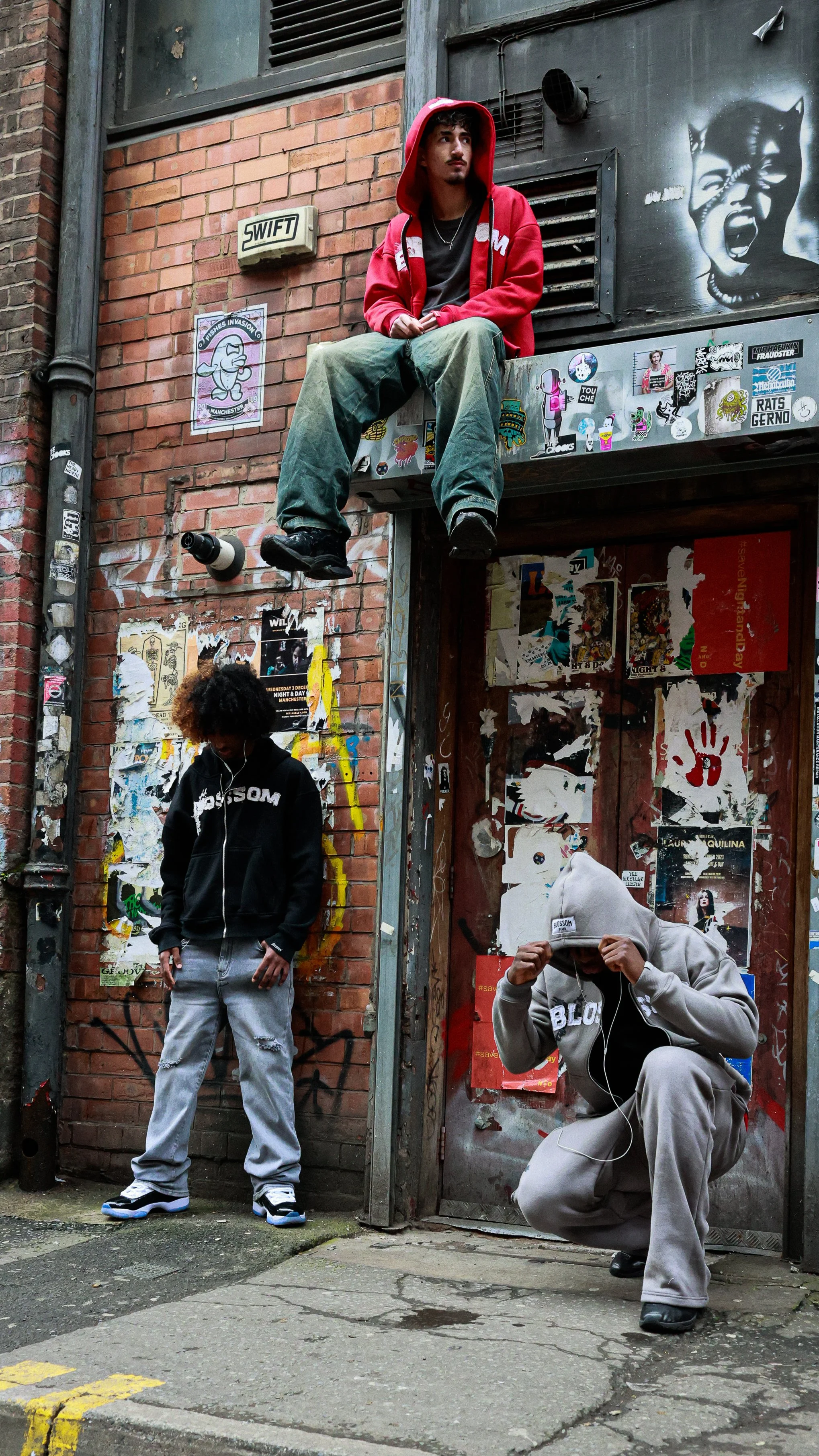A man playing an electric guitar on stage with dark background.