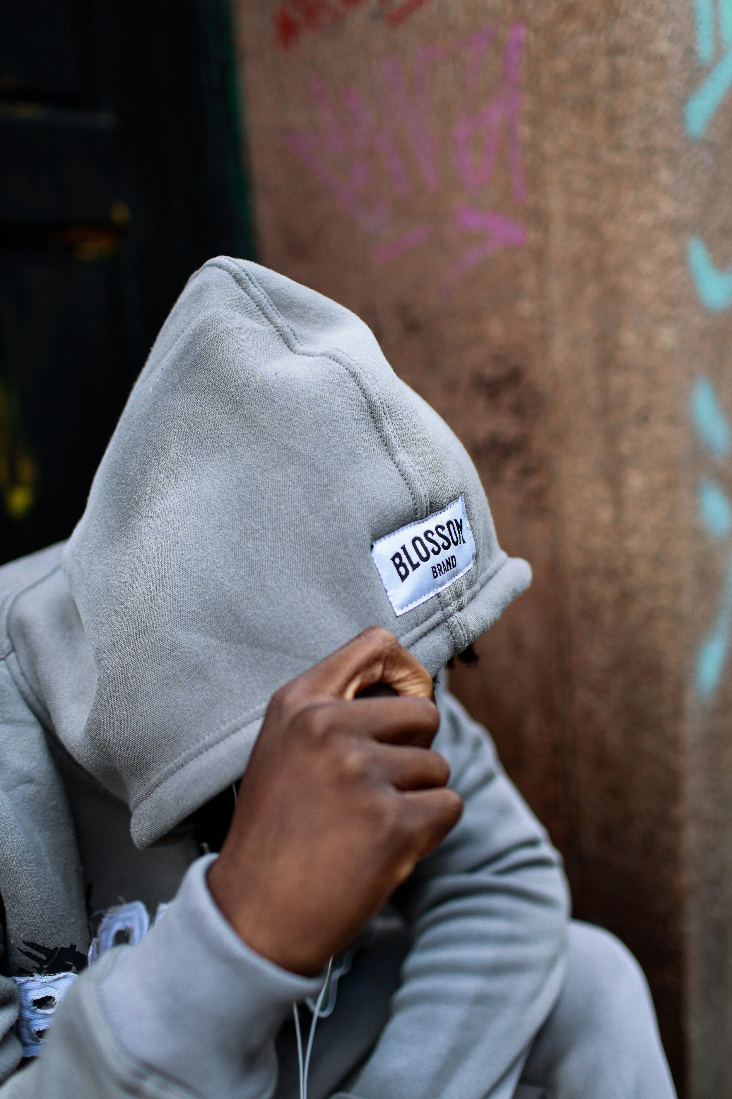 A young girl with blonde hair lying on her back, holding a plush toy, illuminated by red and purple lighting.