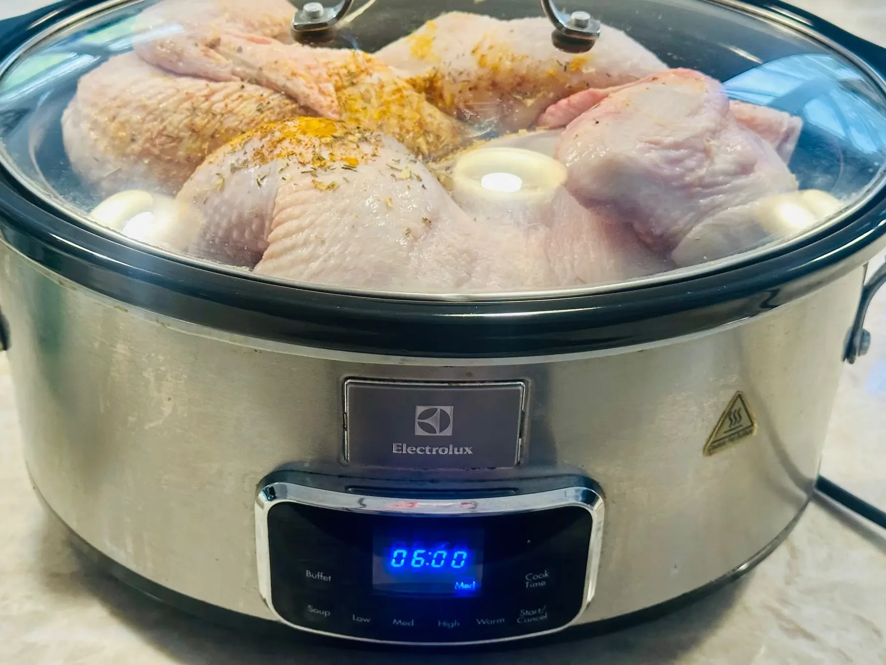 Slow cooking the chicken for NRQi Studio's recipe for bone broth to support with health and wellness from a TCM perspective.