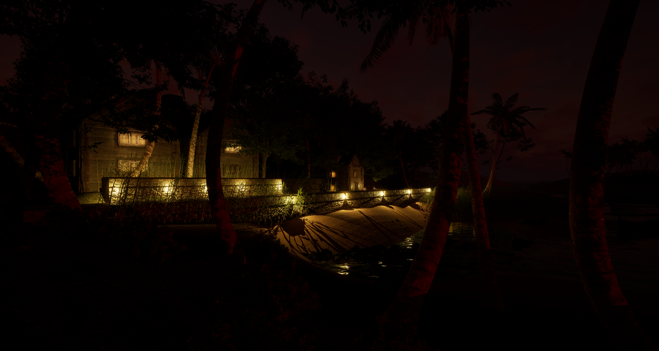 Nighttime view of a house along the water, illuminated by outdoor lights, with trees and palm trees surrounding the area.