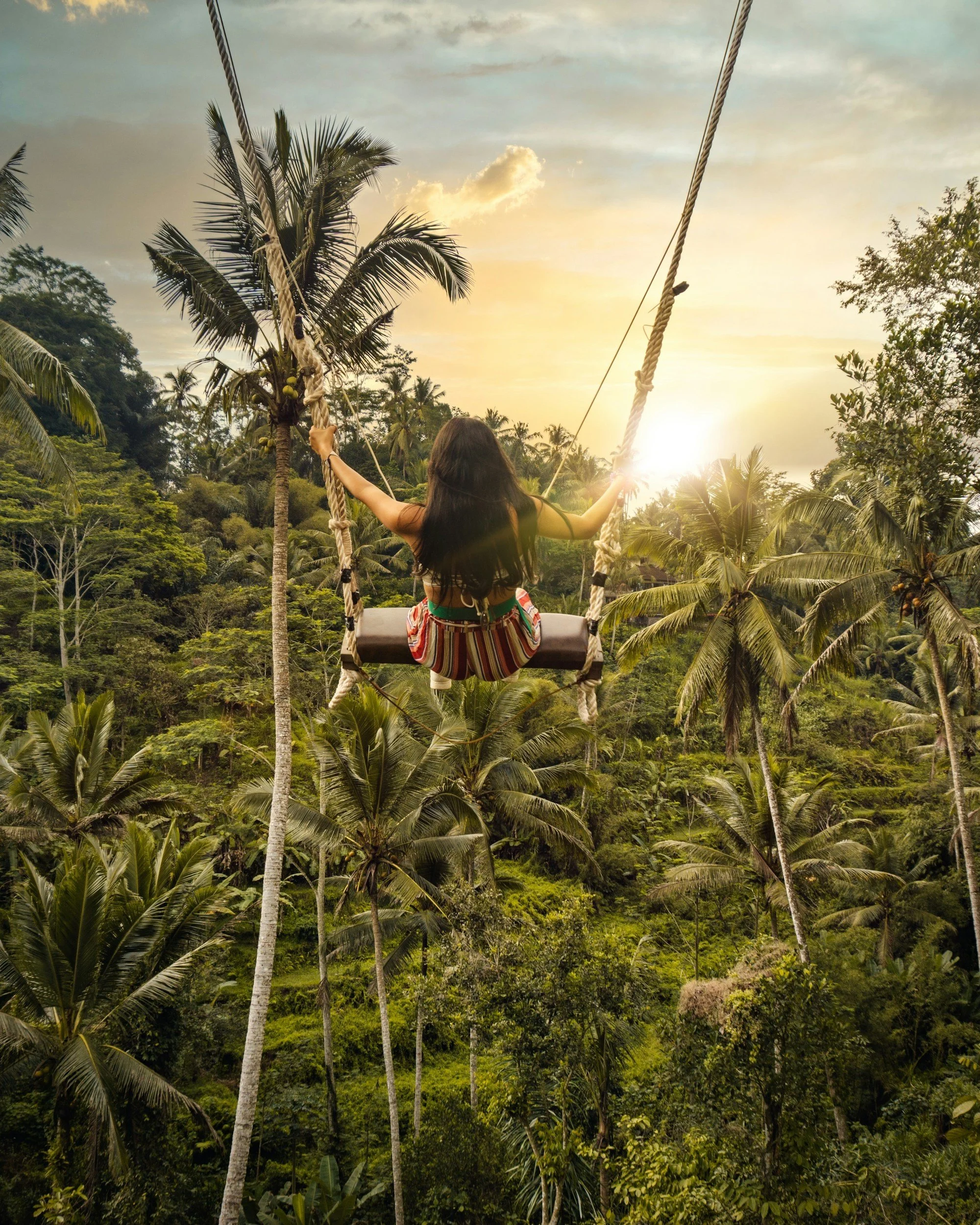 Women on a swing in Ubud, Bali, Indonesia