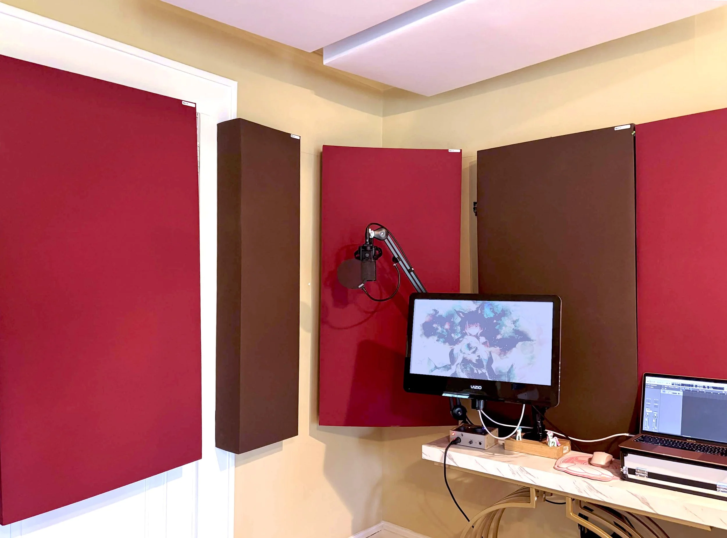 Bay's home recording studio featuring alternating red and brown sound clouds, microphone, and computer area.