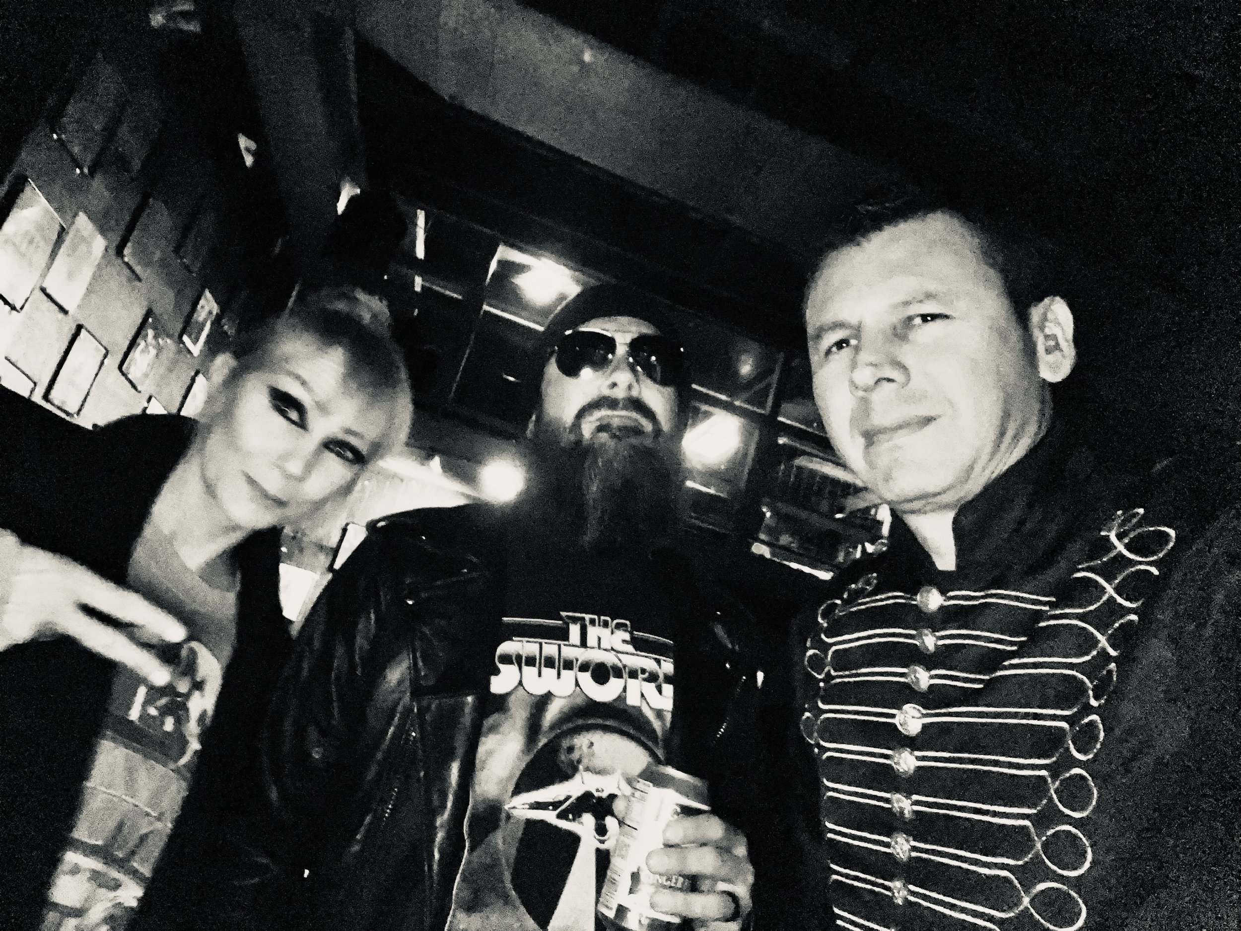 Three people taking a selfie in a dark environment, two men and one woman, with one person wearing sunglasses and the other two smiling. My Mistress at Valhalla Chace Levi Lacey Kay Levi Martin leal
