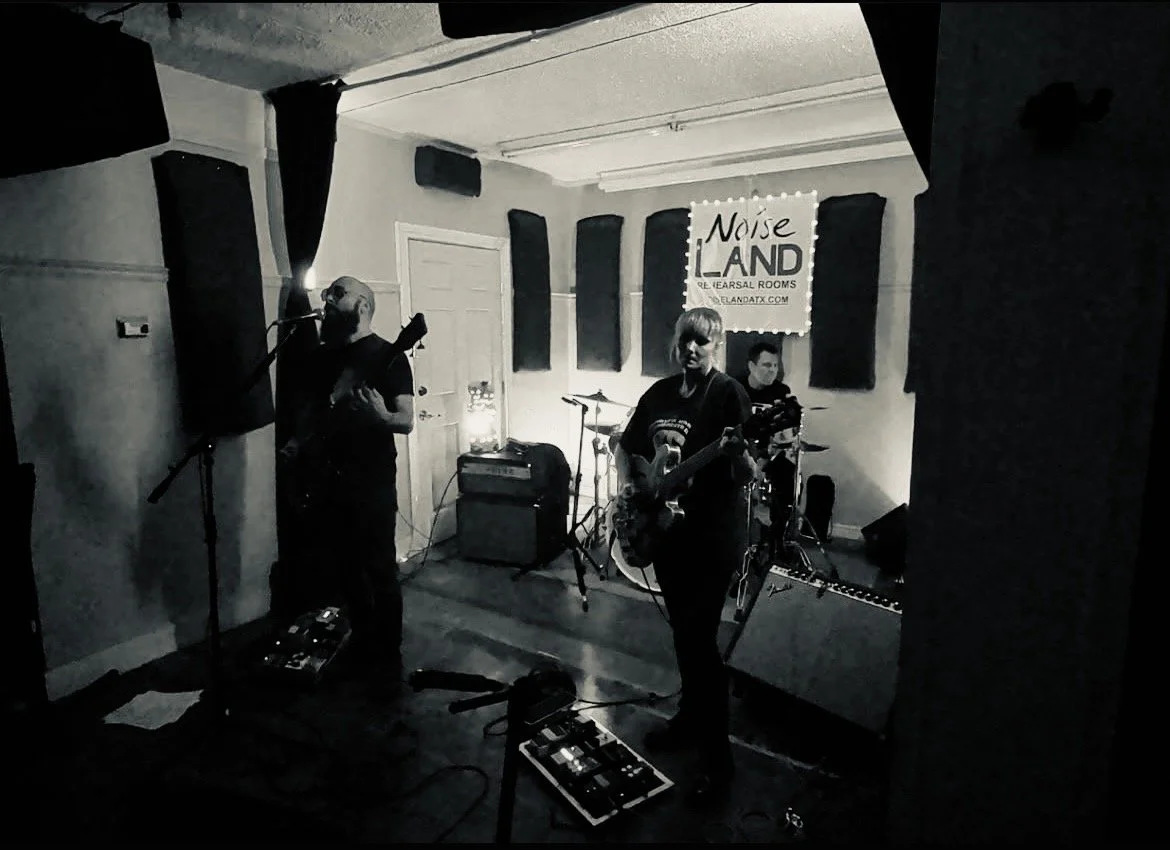 Black and white photo of a band performing in a small room with soundproofing panels on the wallsMy Mistress at NoiselandChace Levi Lacey Kay Levi Martin leal