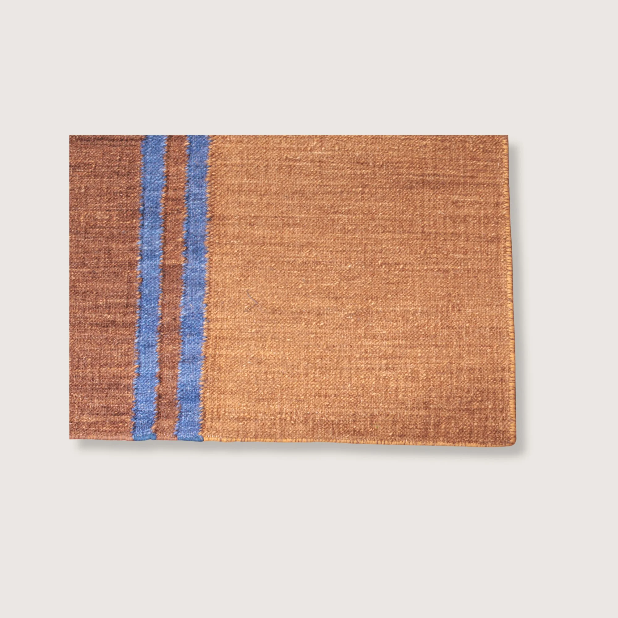 Rekha Do handwoven rug showing texture, earthy tones and tassel detail