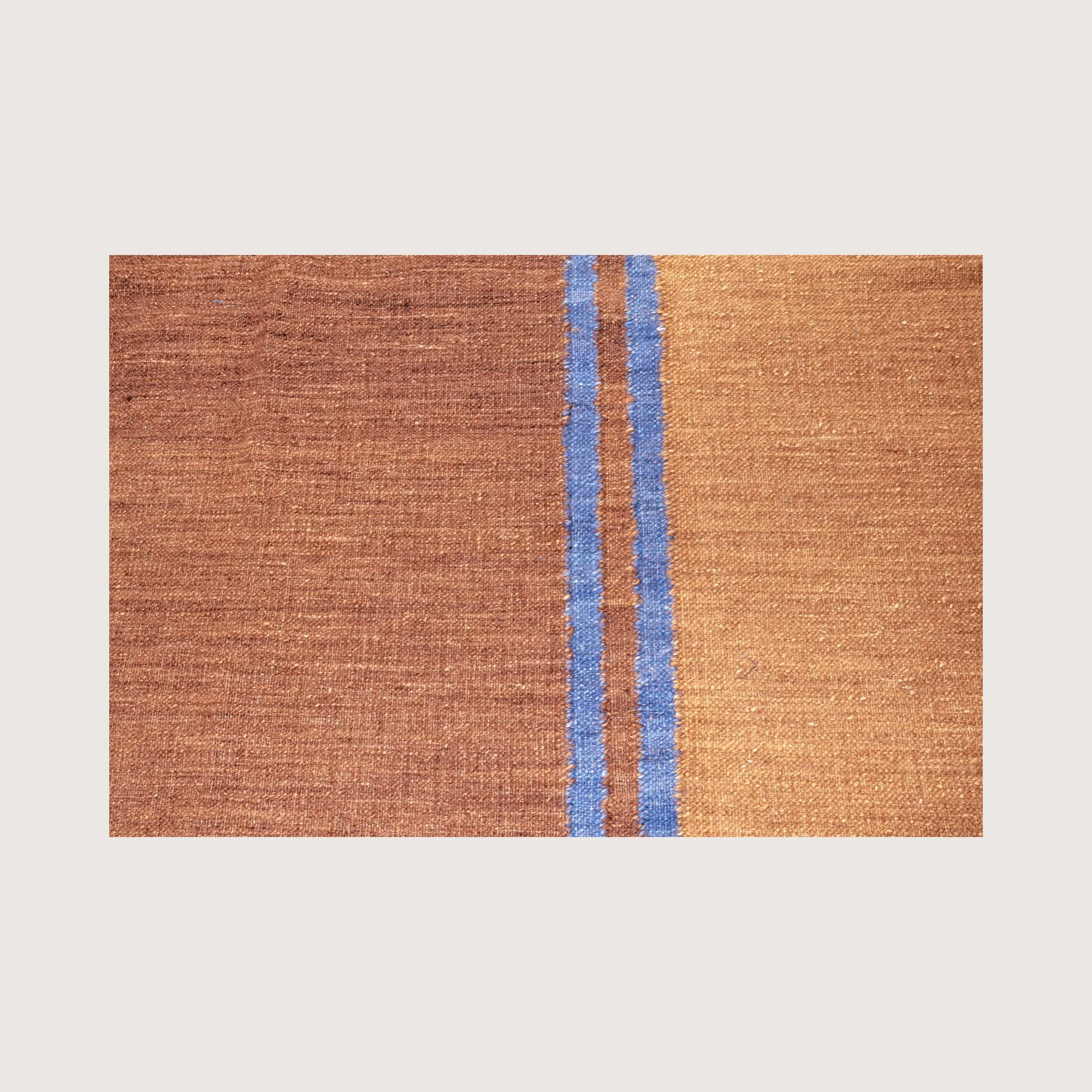 Close-up of Rekha Do rug showing handwoven texture and twin blue line detail