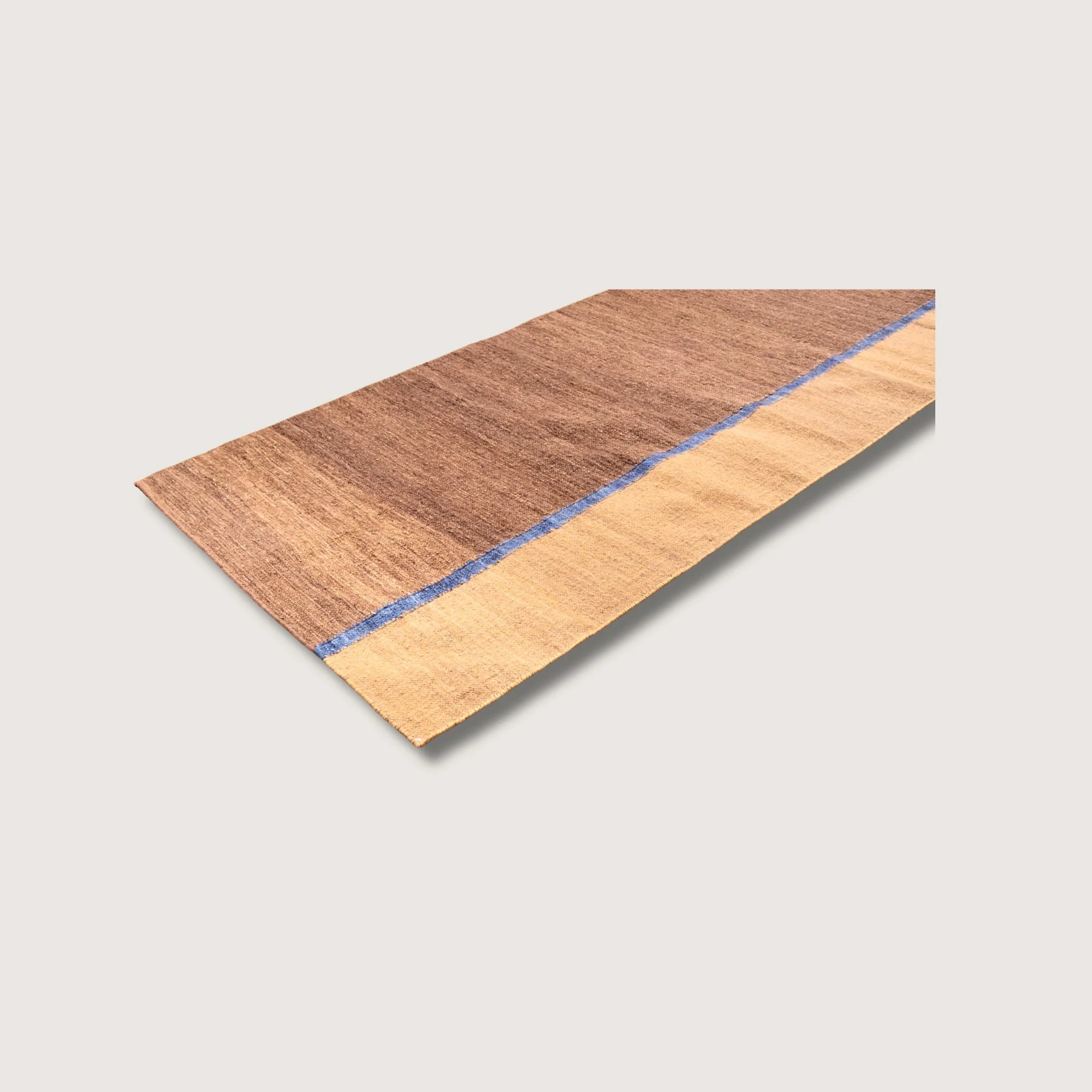 Angled view of Rekha Ek runner with single blue line detail and natural wool texture