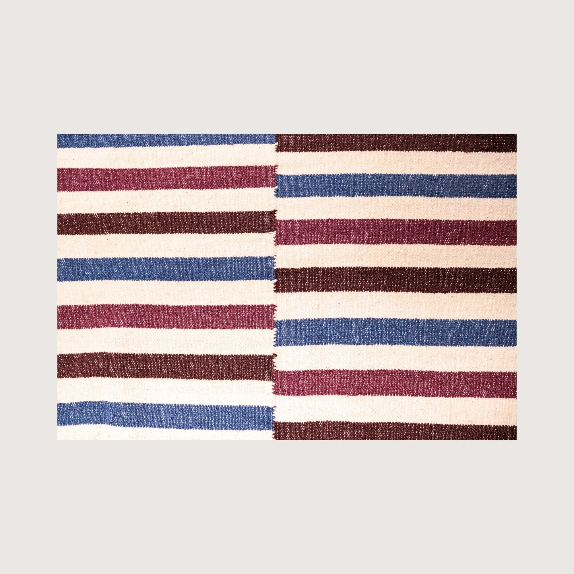 Close-up of Saanjh rug showing handwoven texture and striped pattern detail