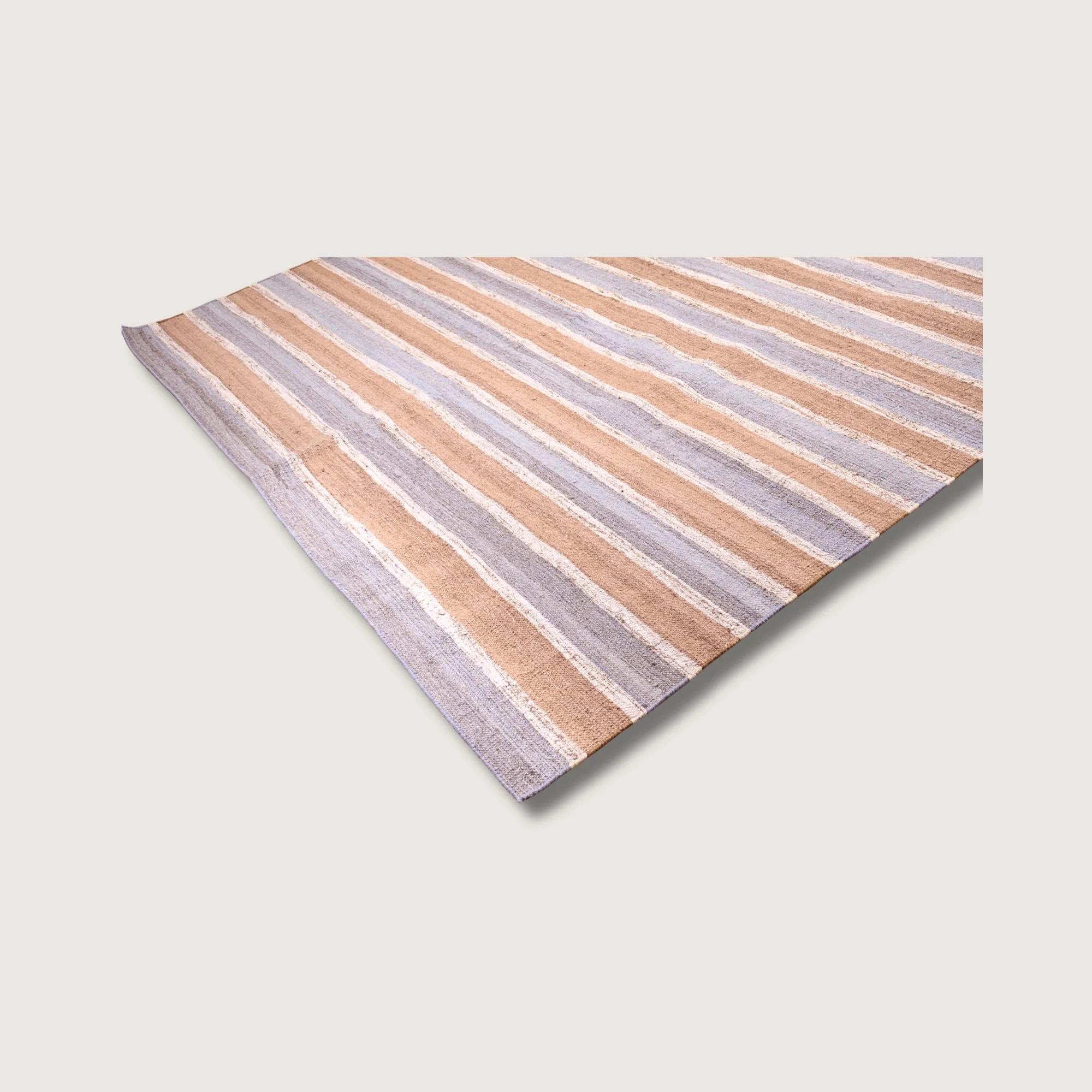 Angled view of Dhaariya Neel rug with blue stripe detail and natural wool texture