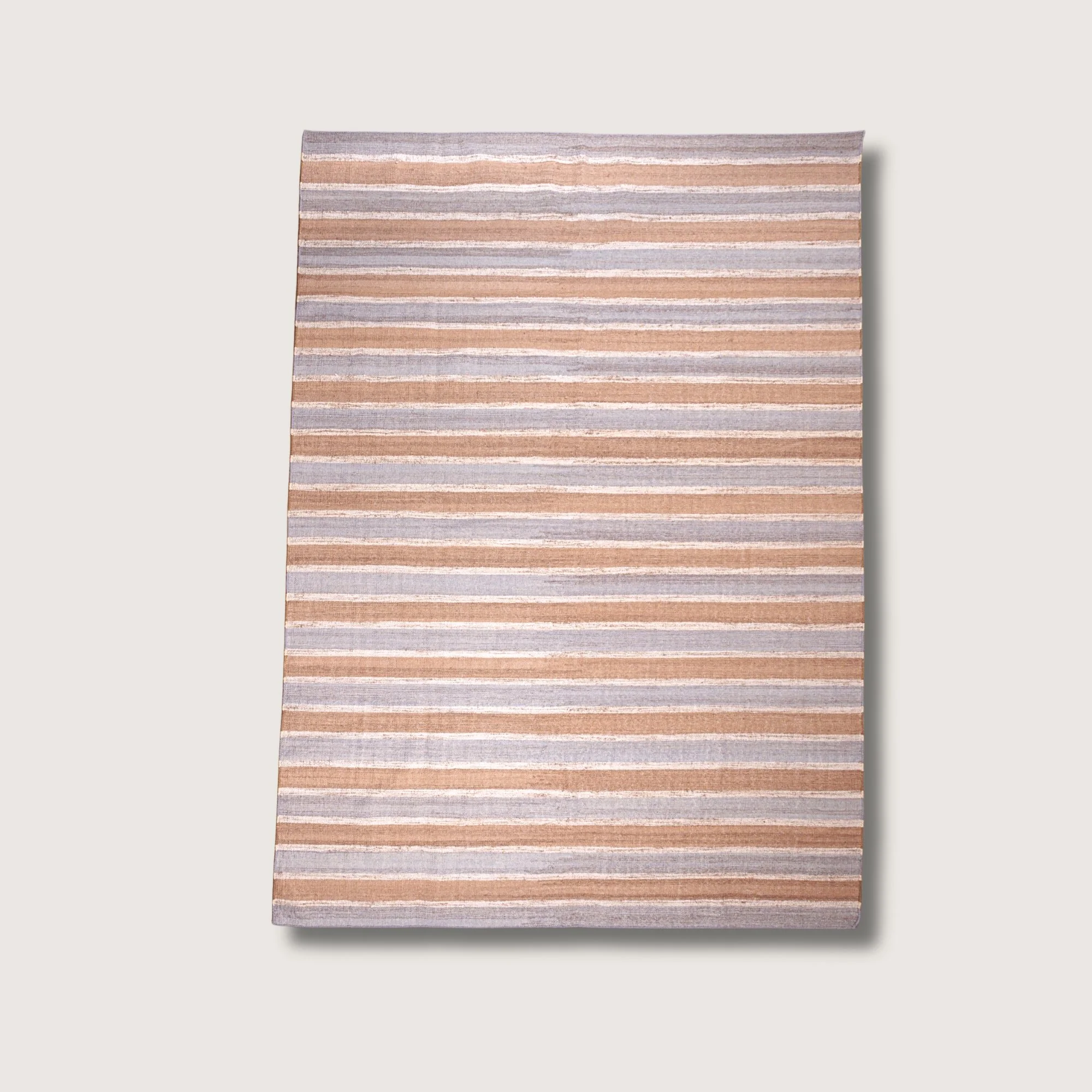 Dhaariya Neel handwoven striped wool rug with blue and natural tones, minimal flatweave design
