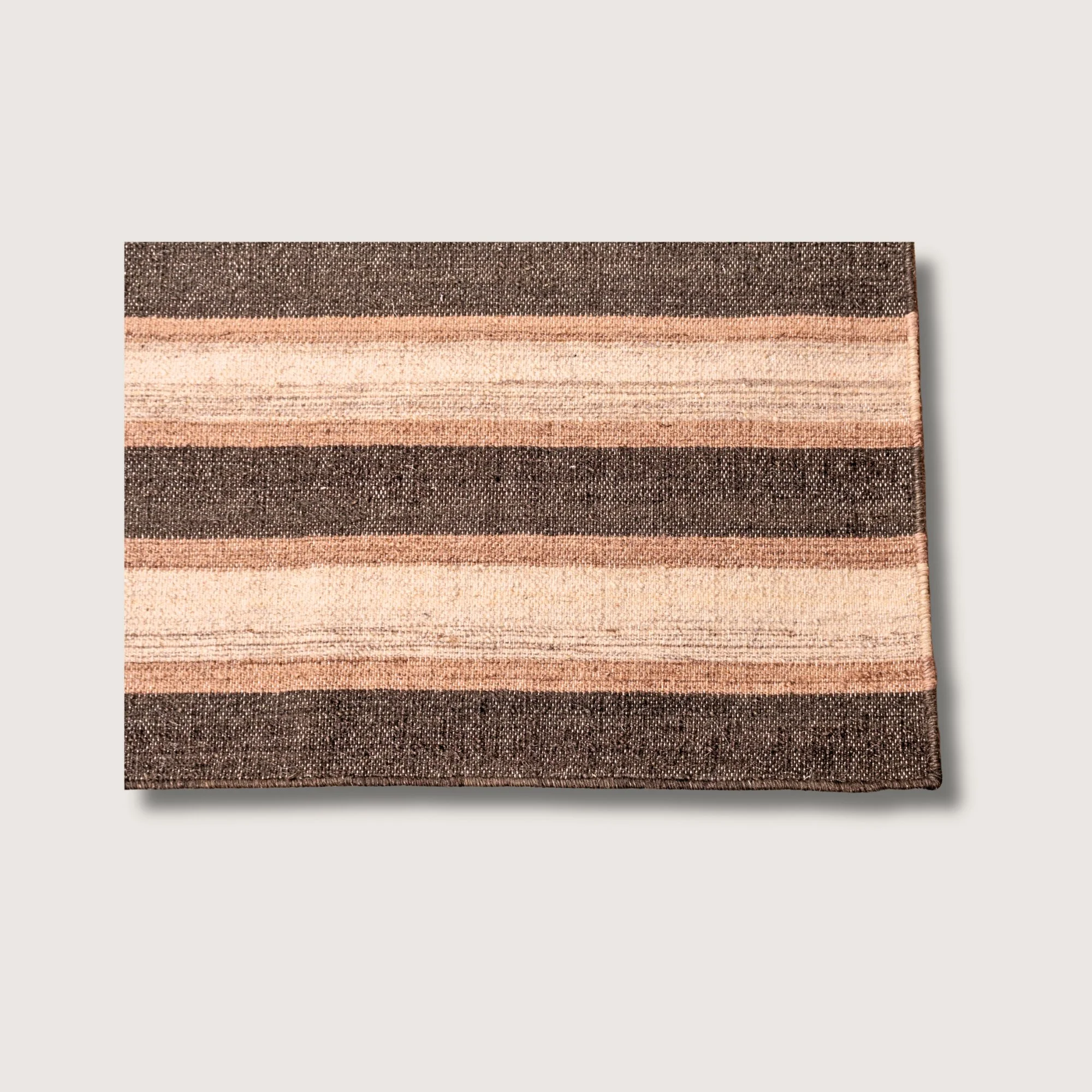 Dhaariya Mitti rug showing striped pattern, texture and tonal variation