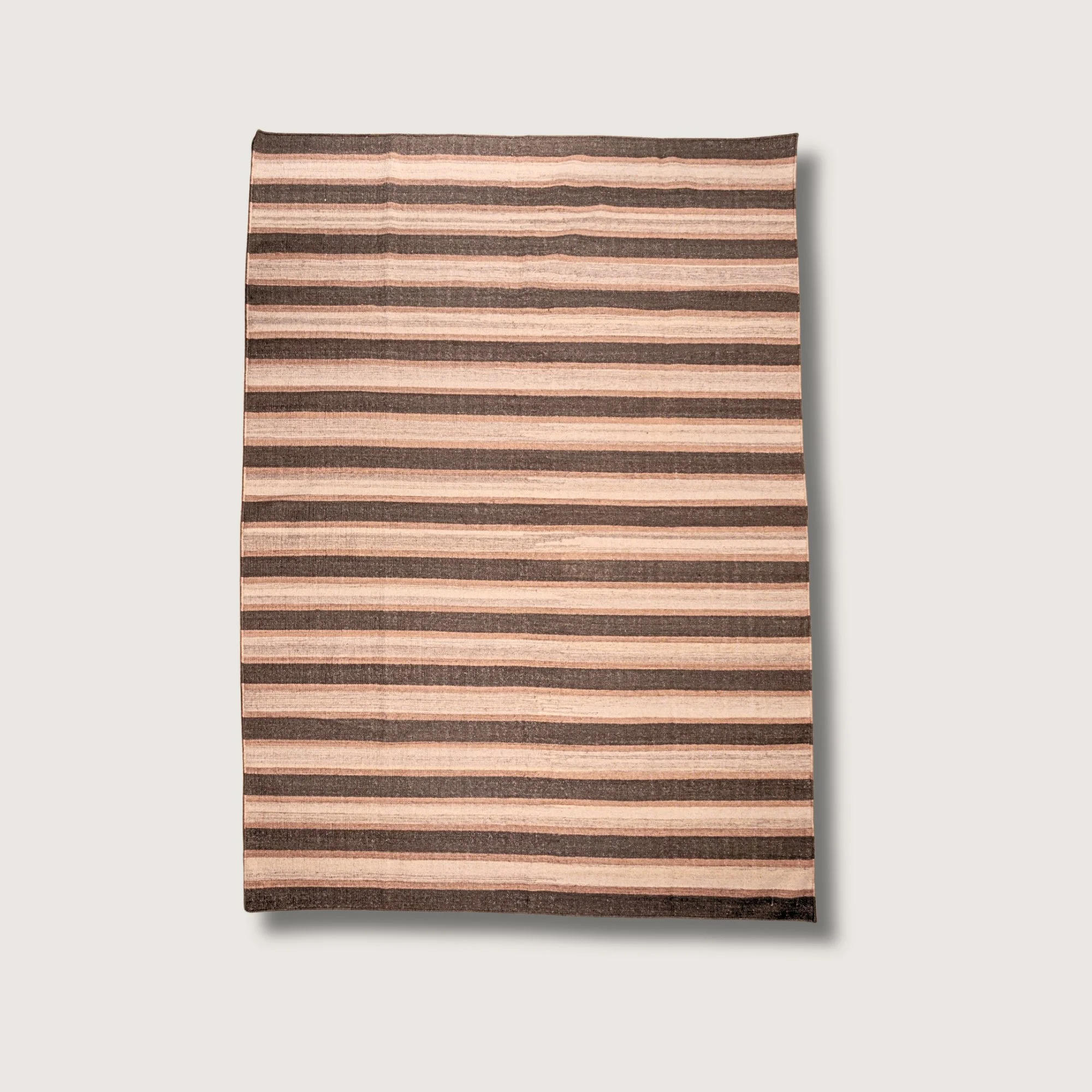 Dhaariya Mitti handwoven striped wool rug with brown and natural tones, earthy flatweave design