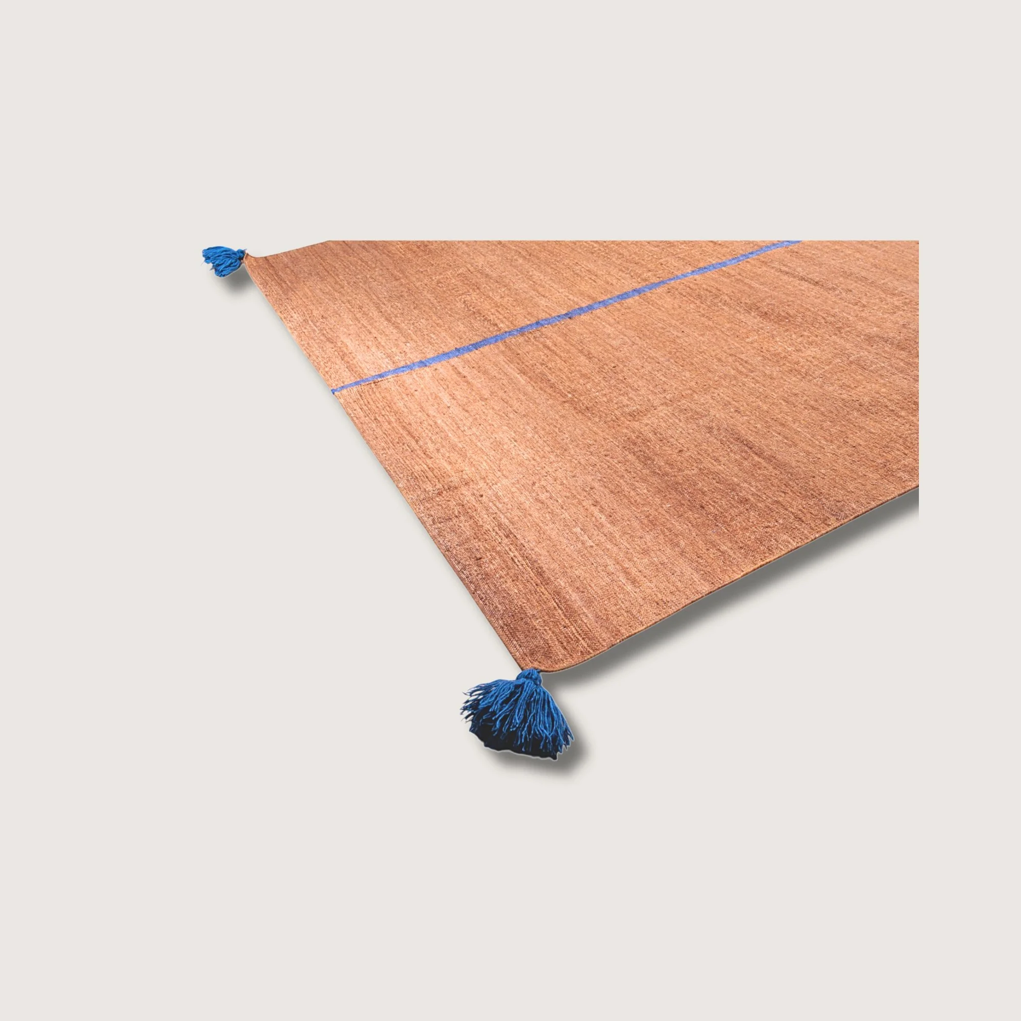 Angled view of Lakir Neel rug with blue line detail and natural wool texture