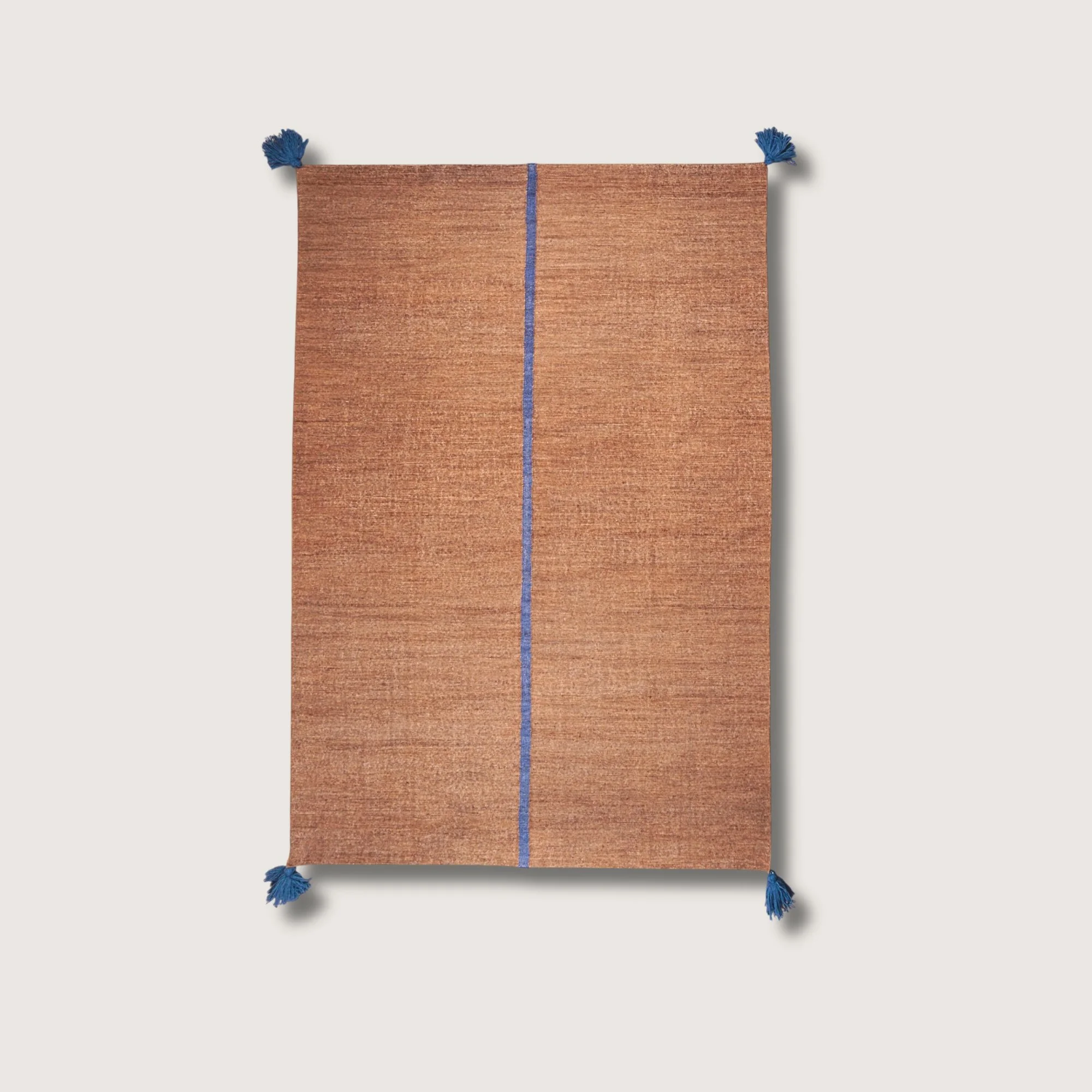 Lakir Neel handwoven wool rug with brown tones and a single blue vertical line, minimal flatweave design