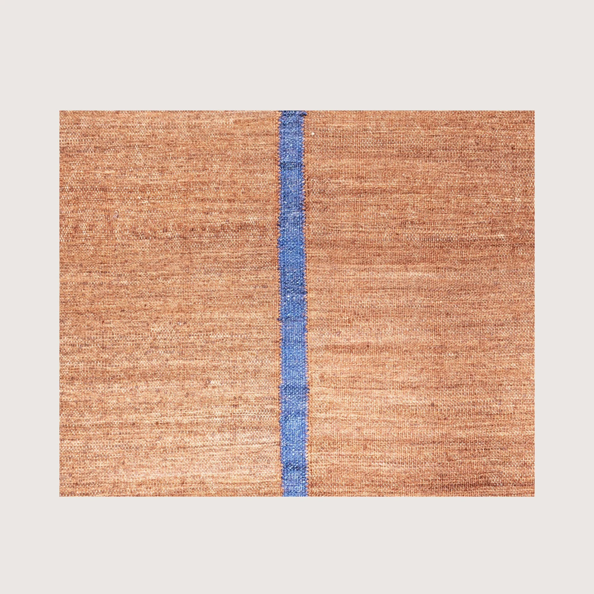 Close-up of Lakir Neel rug showing handwoven texture and central blue line detail