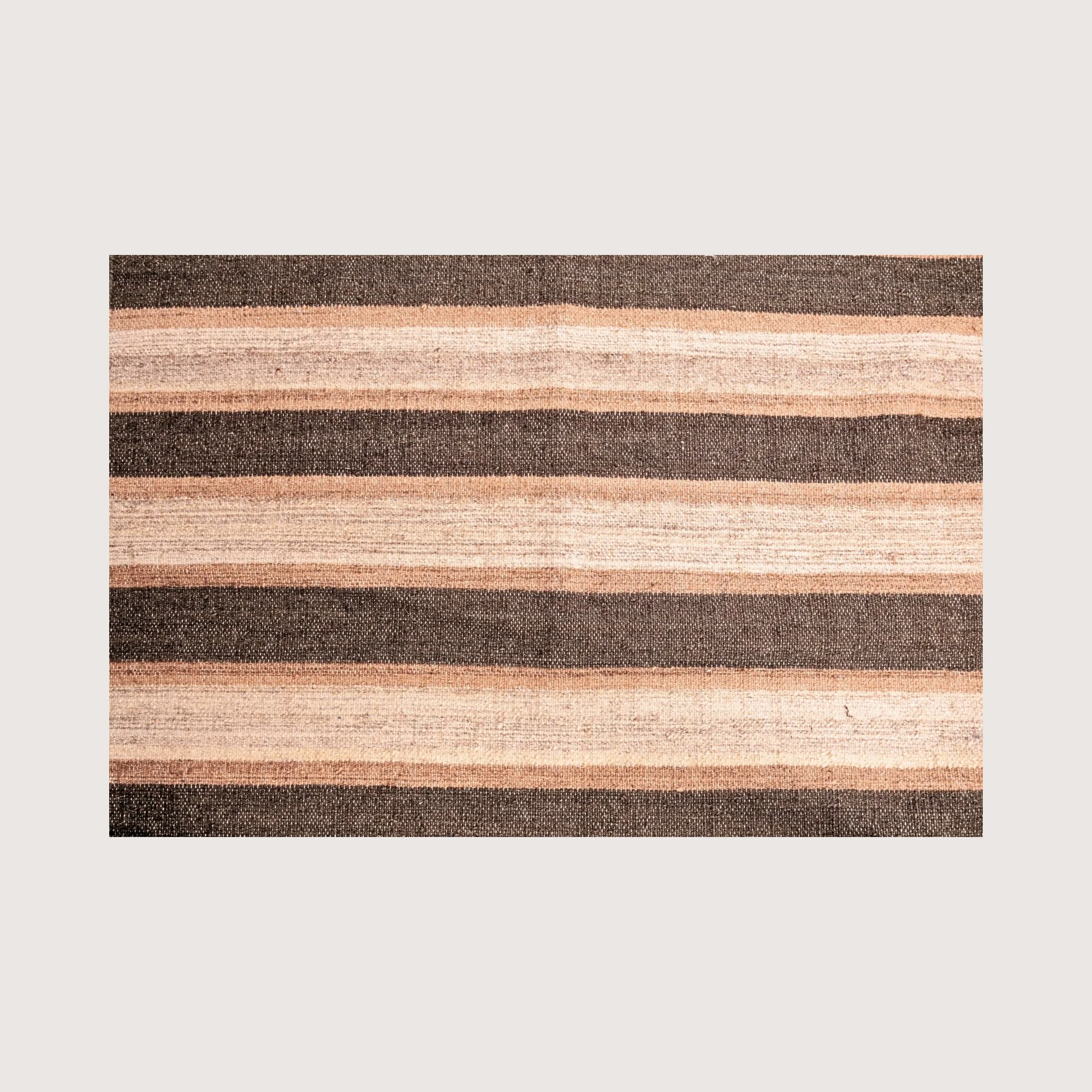 Close-up of Dhaariya Mitti rug showing handwoven texture and stripe detail