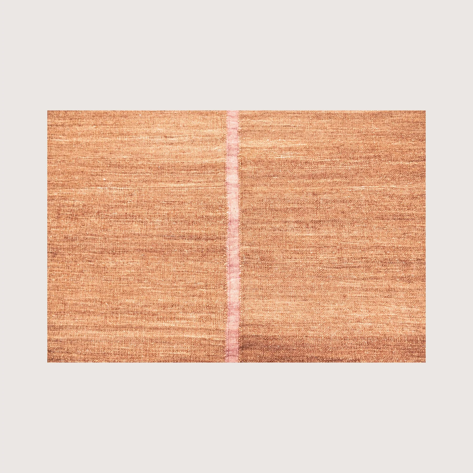 Close-up of Lakir Gulab rug showing handwoven texture and central pink line detail