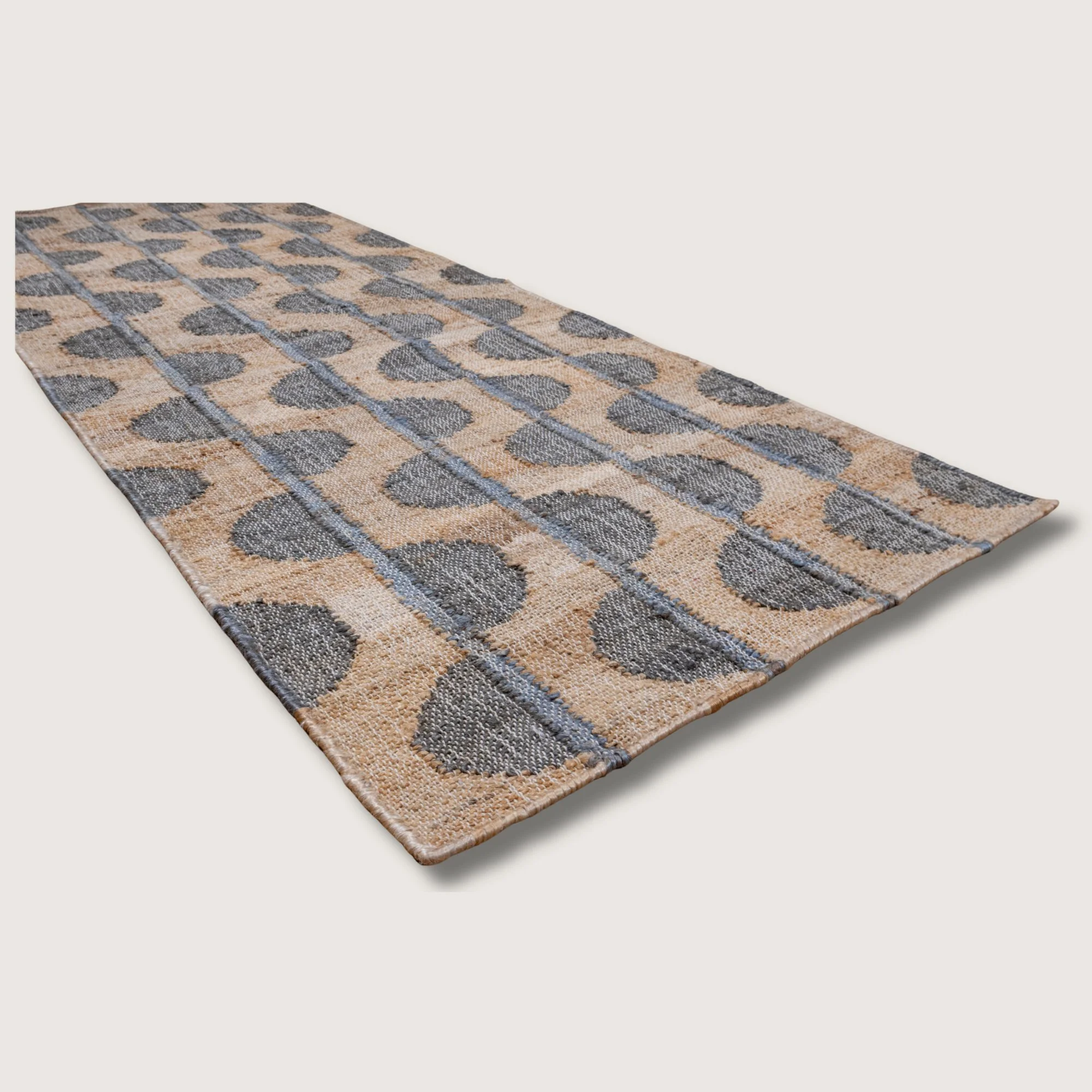 Handwoven jute runner with repeating half-moon pattern in muted zaitun and natural sand tones with fine slate-grey detailing.