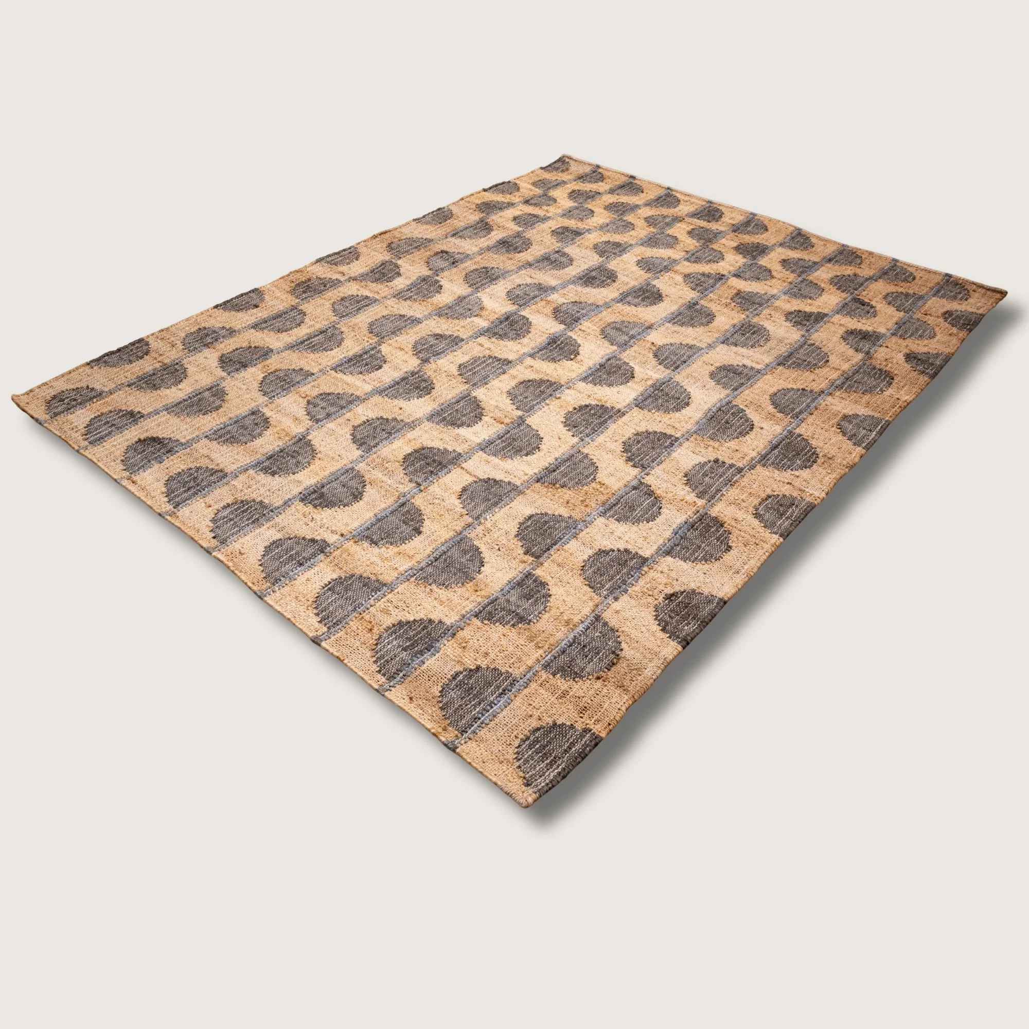 Handwoven jute rug with repeating half-moon pattern in muted zaitun and natural sand tones.
