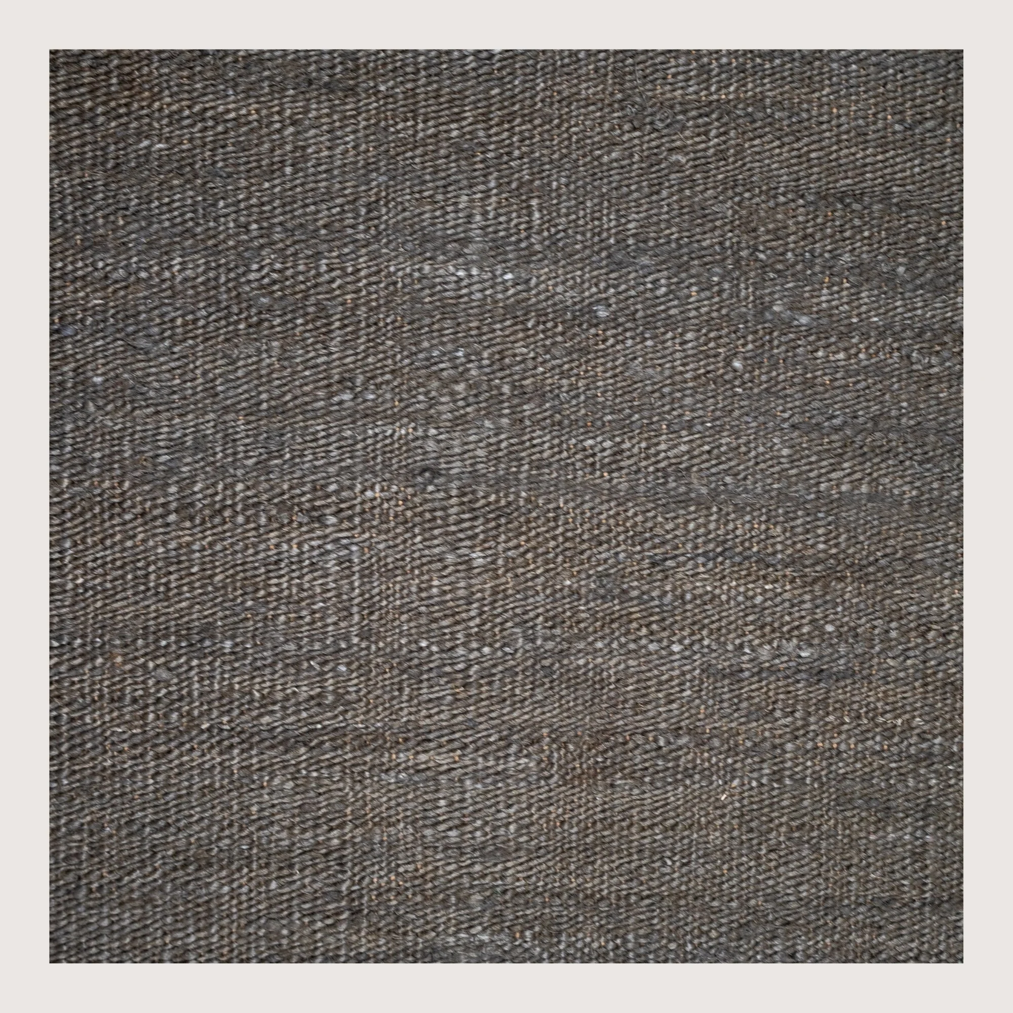 Plain handwoven jute rug in muted zaitun tones with subtle natural texture.