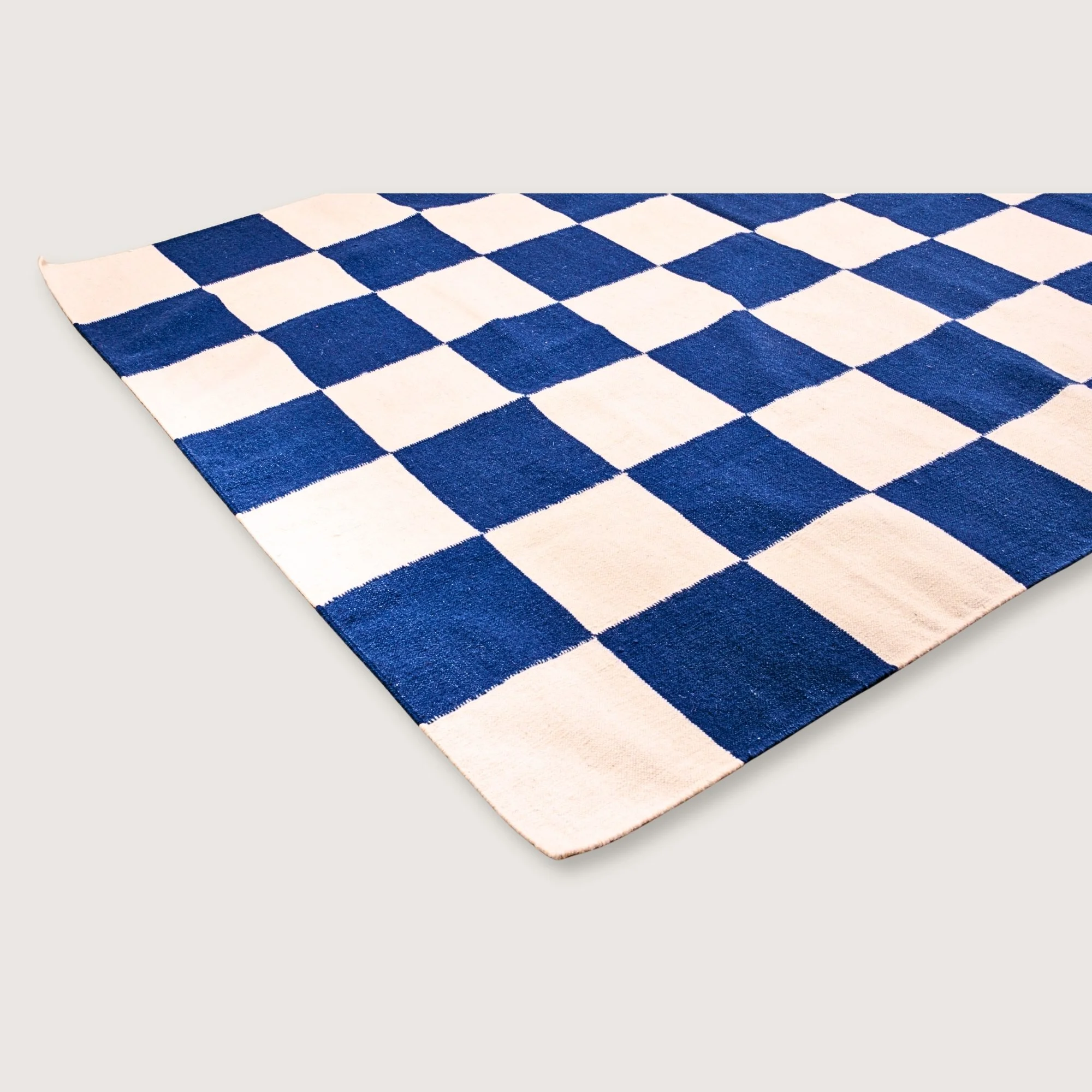 Khana Neel handwoven checkered wool rug with blue and natural squares, flatweave design
