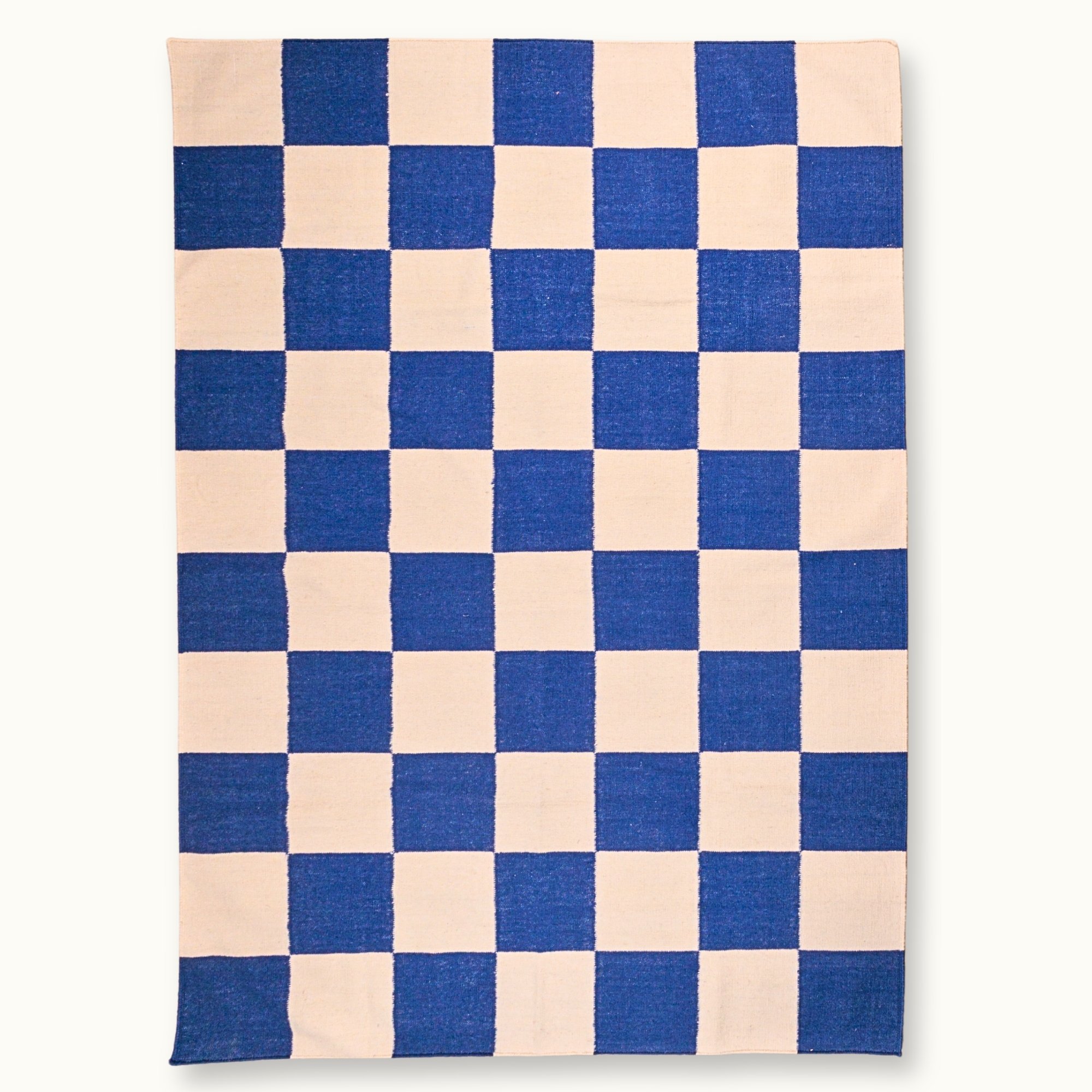 Khana Neel handwoven checkered wool rug with blue and natural squares, flatweave design