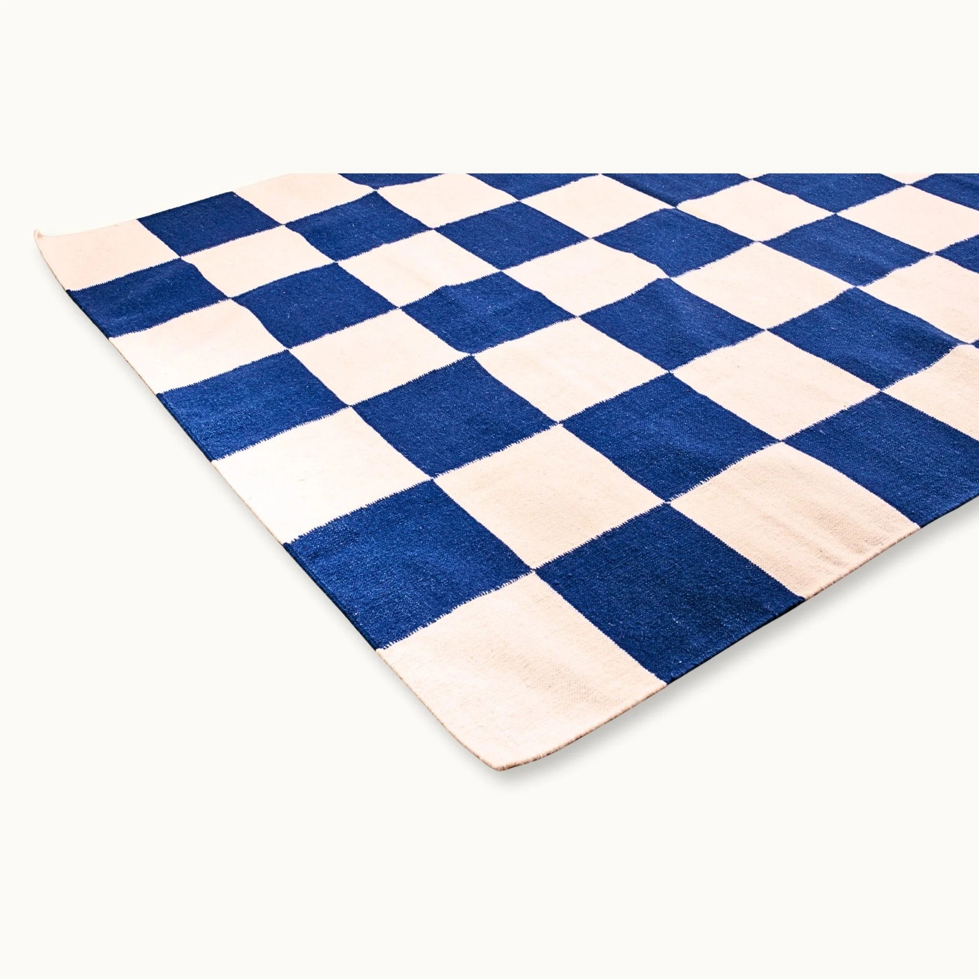 Khana Neel handwoven checkered wool rug with blue and natural squares, flatweave design