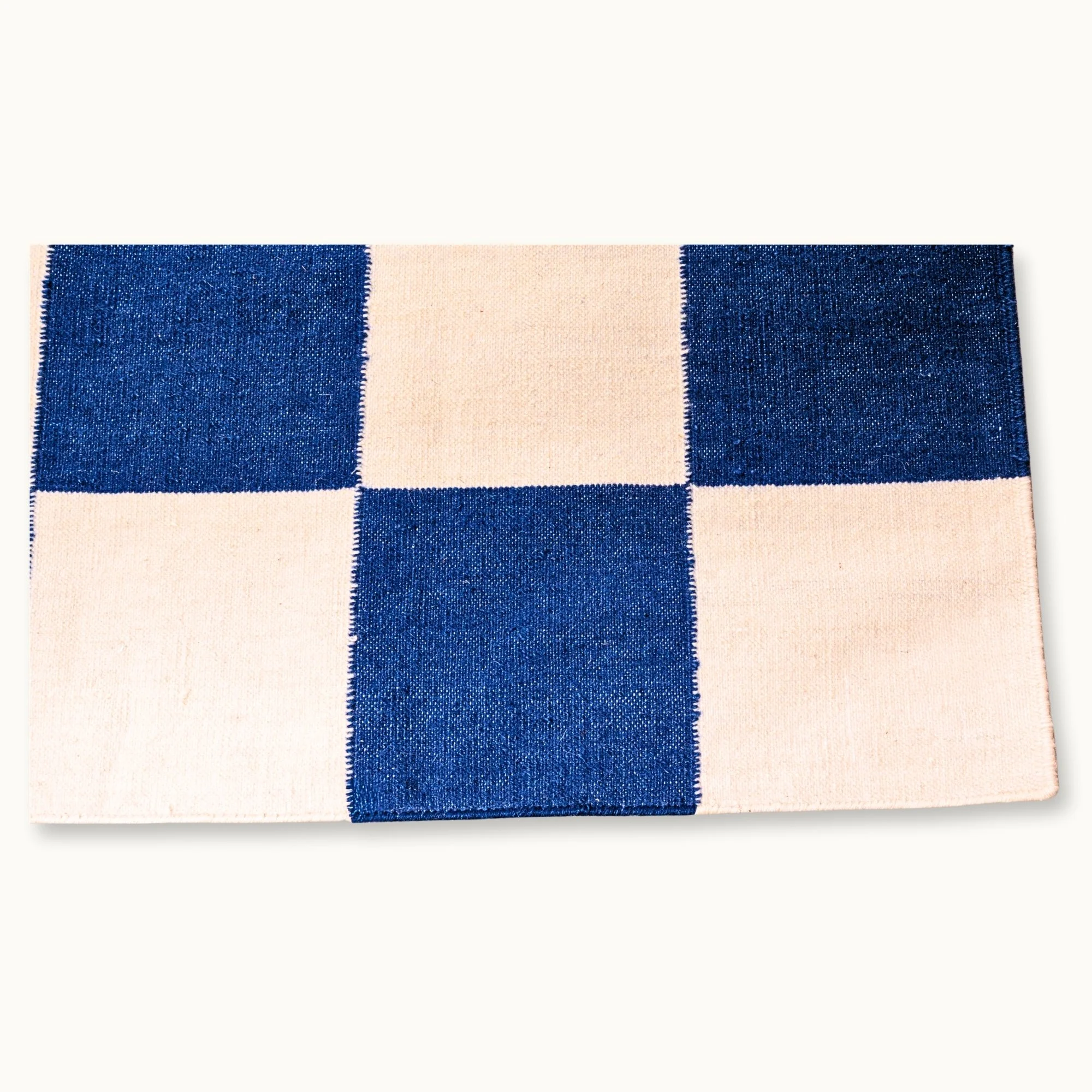 Khana Neel handwoven checkered wool rug with blue and natural squares, flatweave design
