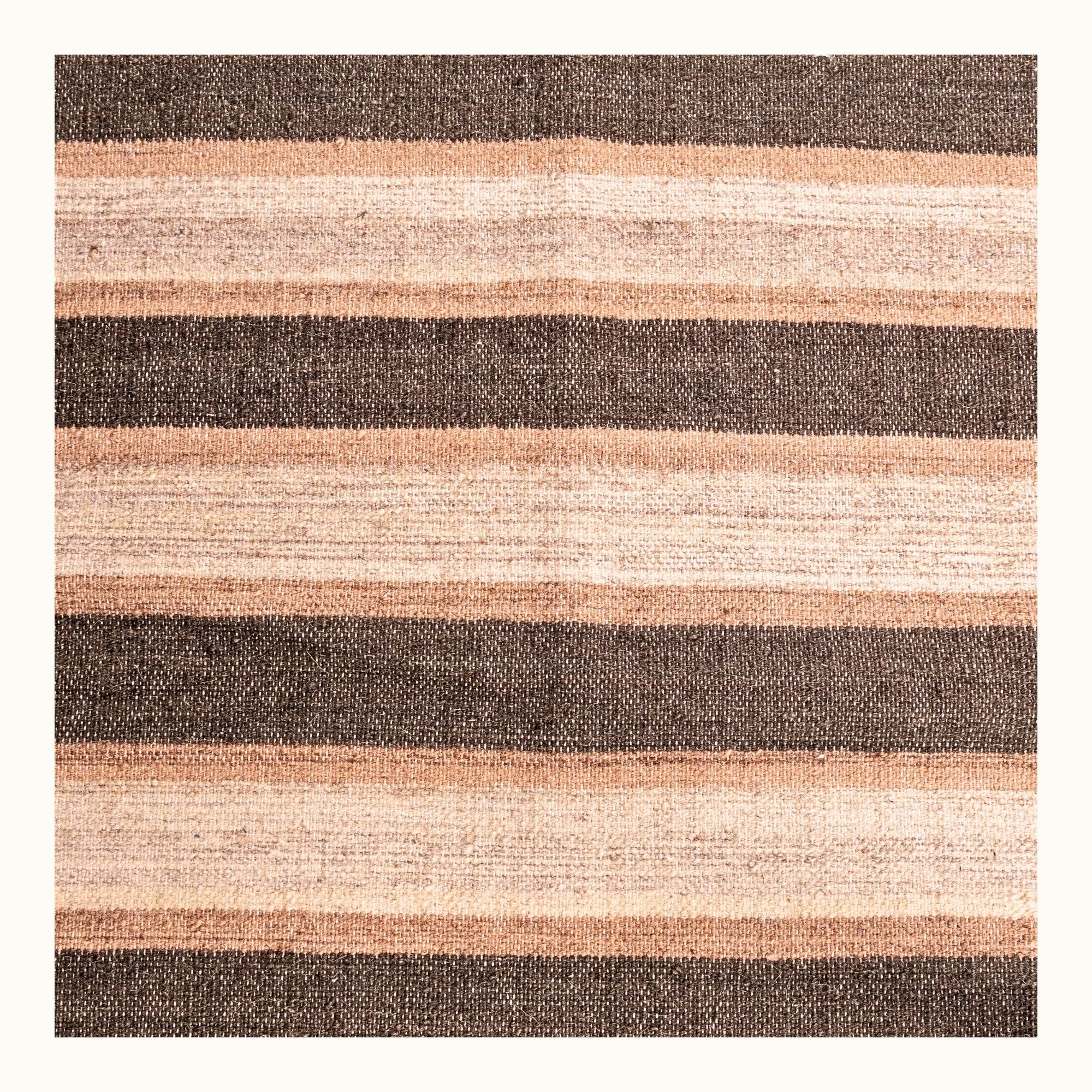 Dhaariya Mitti handwoven striped wool rug with brown and natural tones, earthy flatweave design