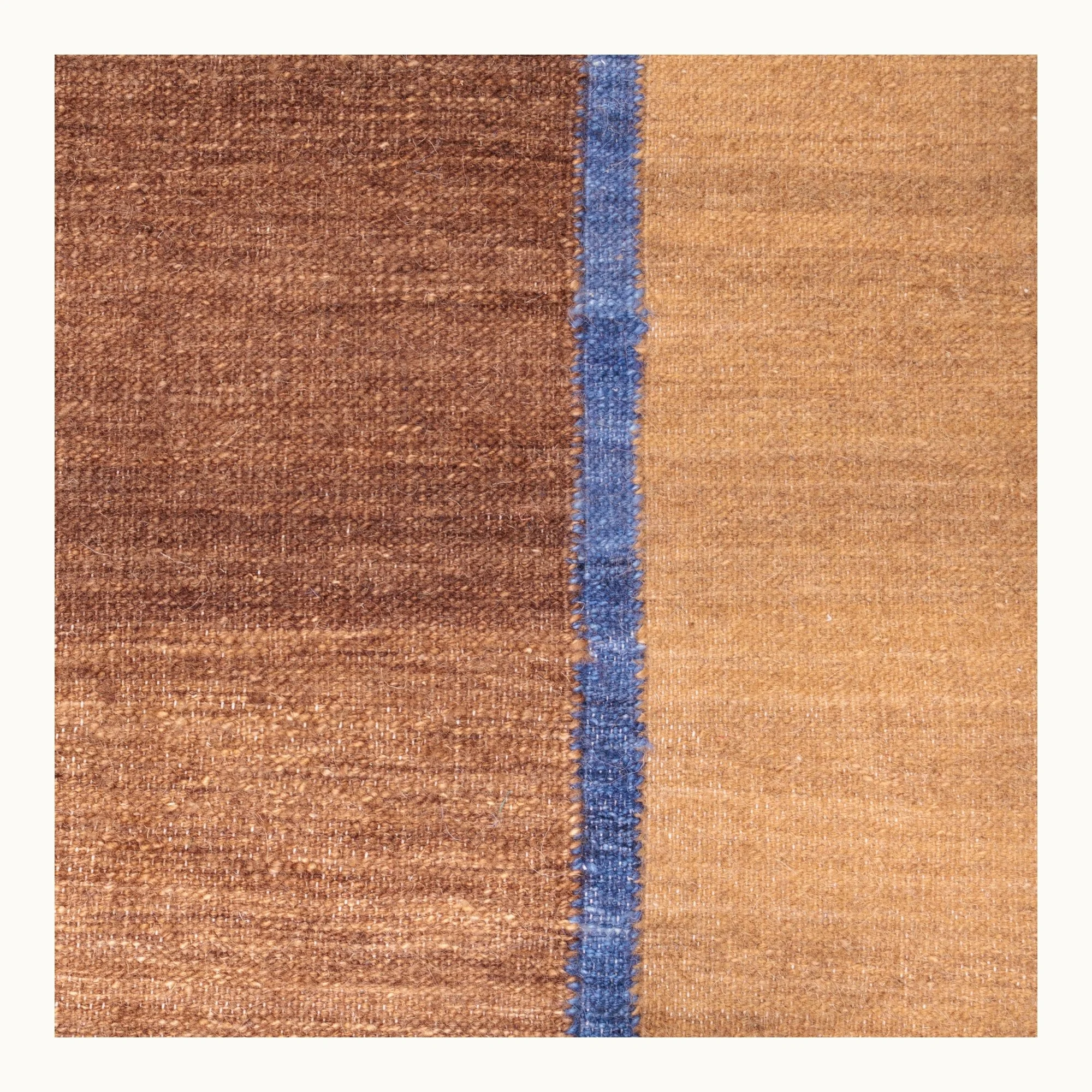 Rekha Ek handwoven wool runner with brown tones and a single blue vertical line, minimal flatweave design