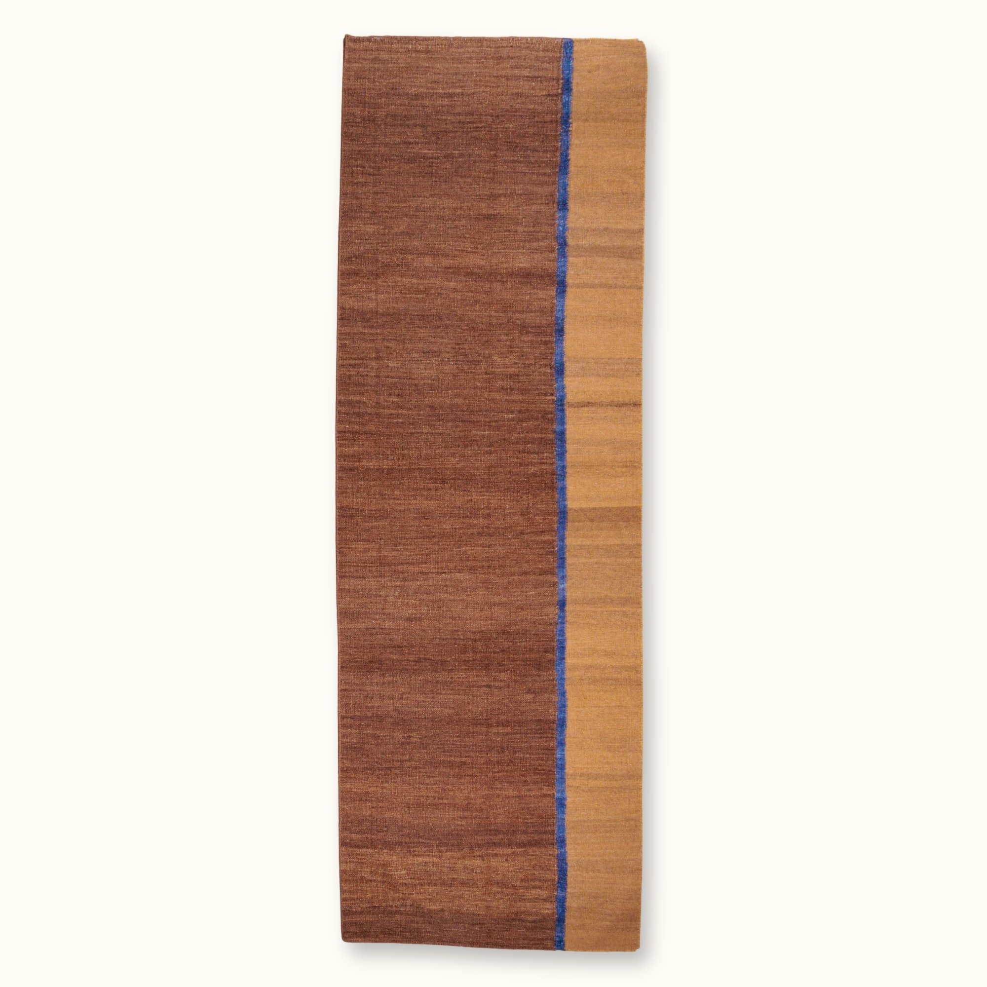 Rekha Ek handwoven wool runner with brown tones and a single blue vertical line, minimal flatweave design