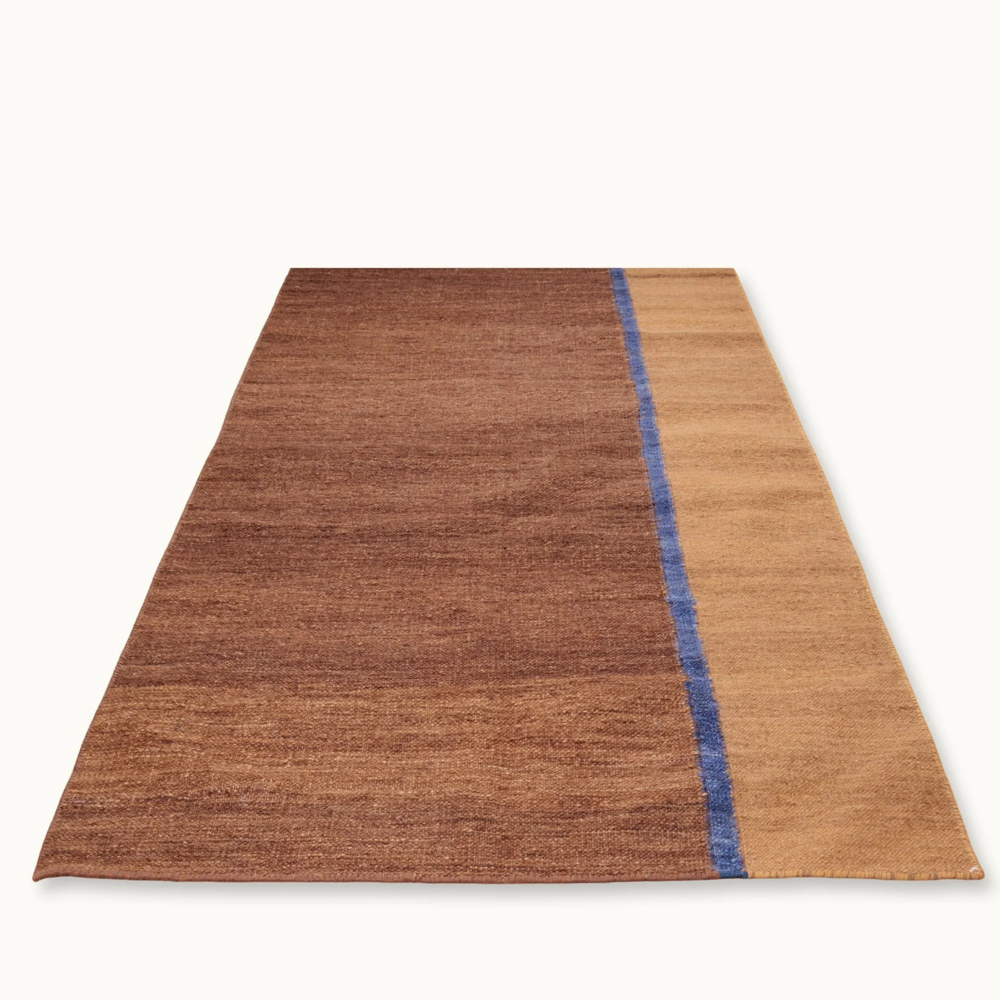 Rekha Ek handwoven wool runner with brown tones and a single blue vertical line, minimal flatweave design
