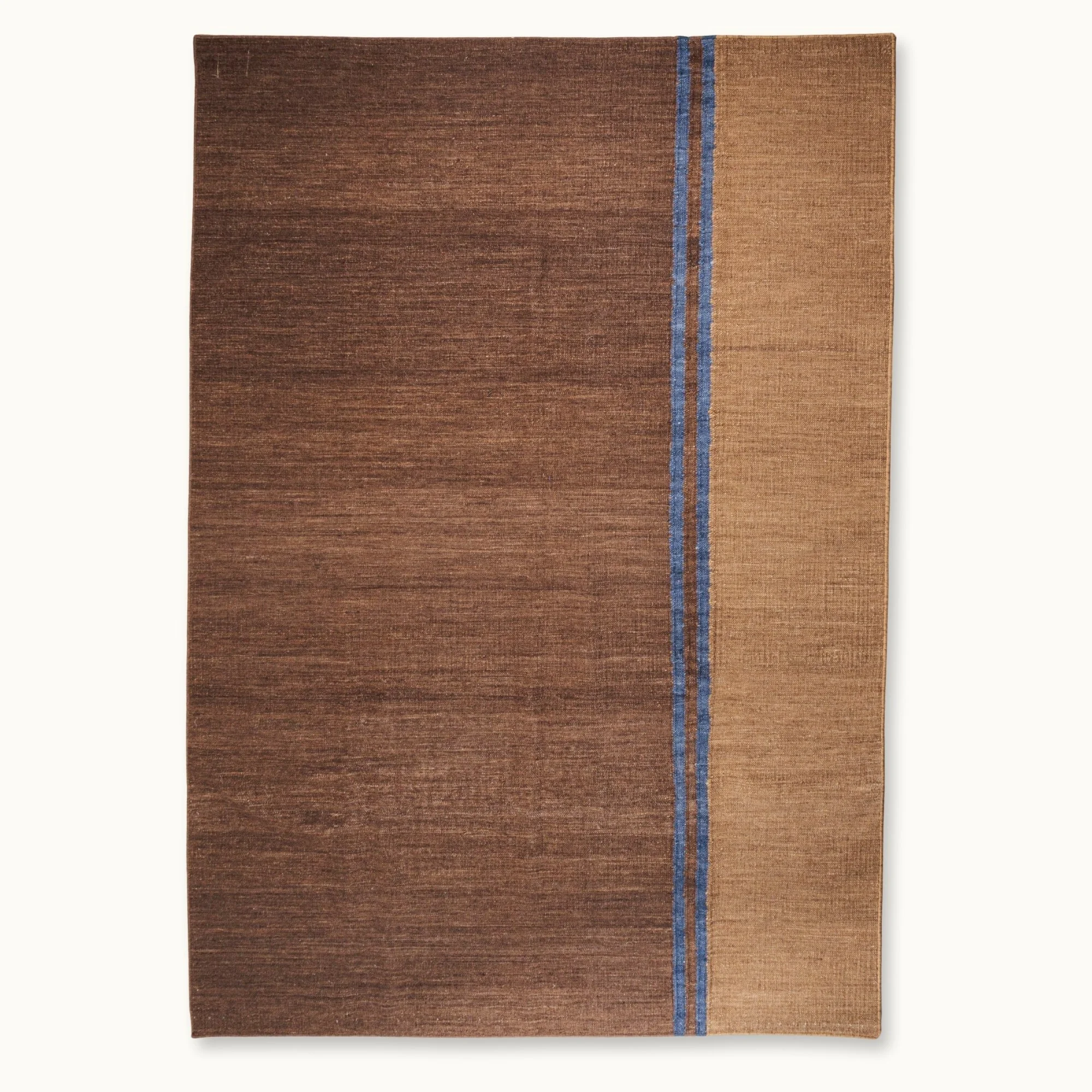 Rekha Do handwoven rug with double blue line detail and natural wool texture