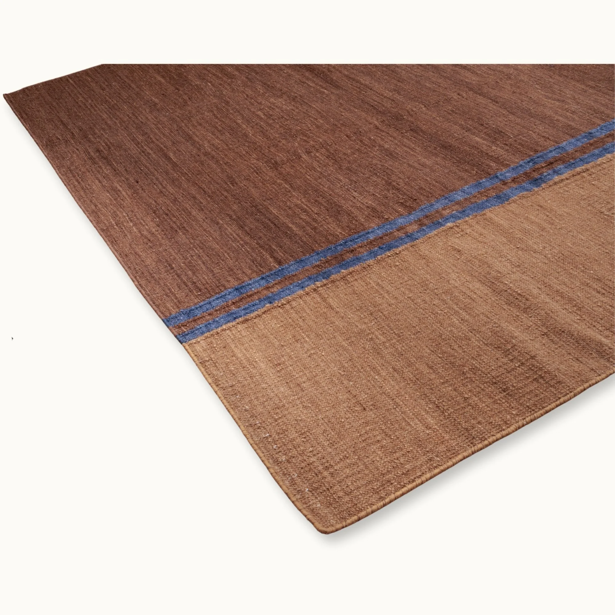 Rekha Do handwoven rug with double blue line detail and natural wool texture