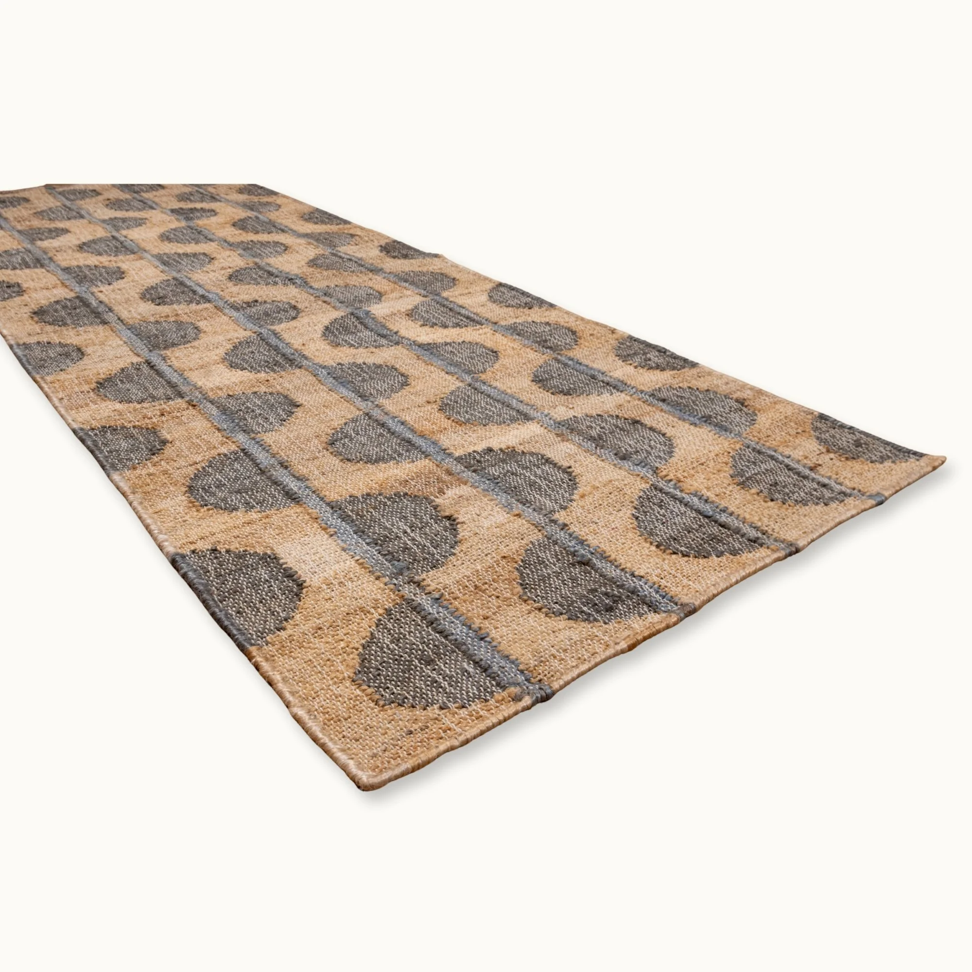 Handwoven jute rug with repeating half-moon pattern in olive green and natural sand tones.